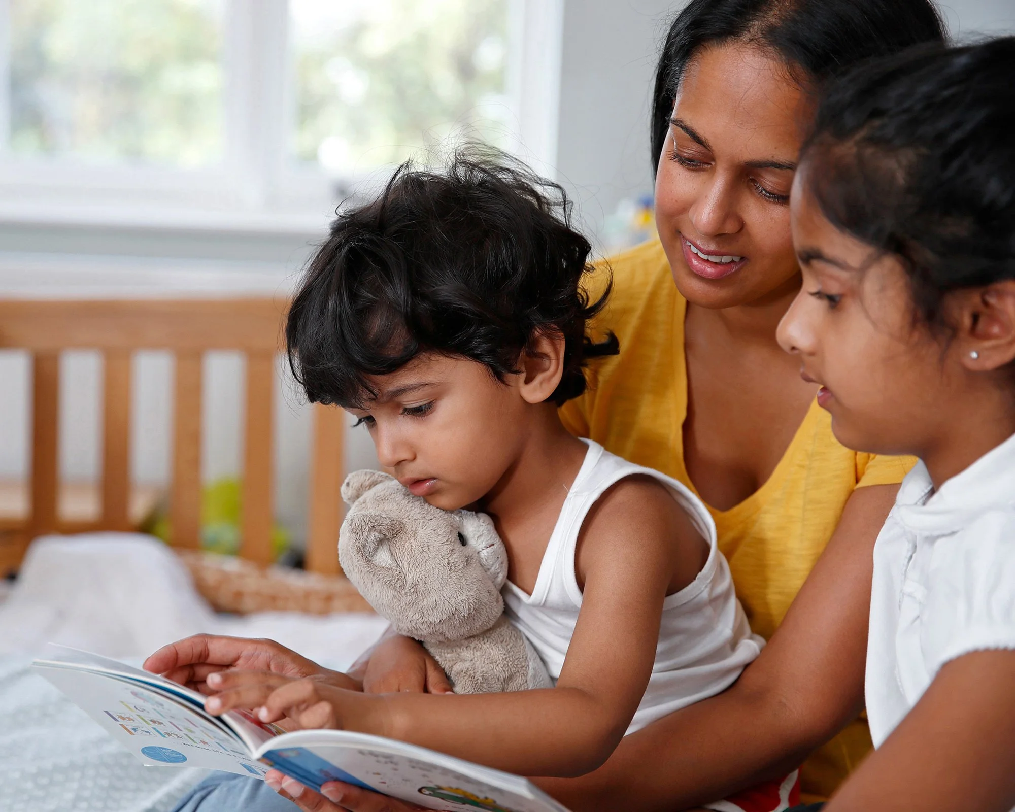 a-mother-reads-to-her-young-children.jpg