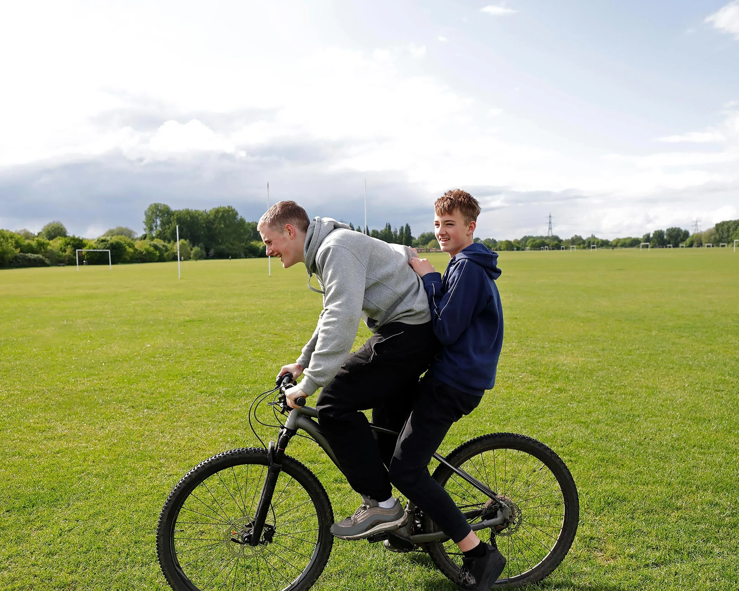 friends-cycling-a-bike-together.jpg