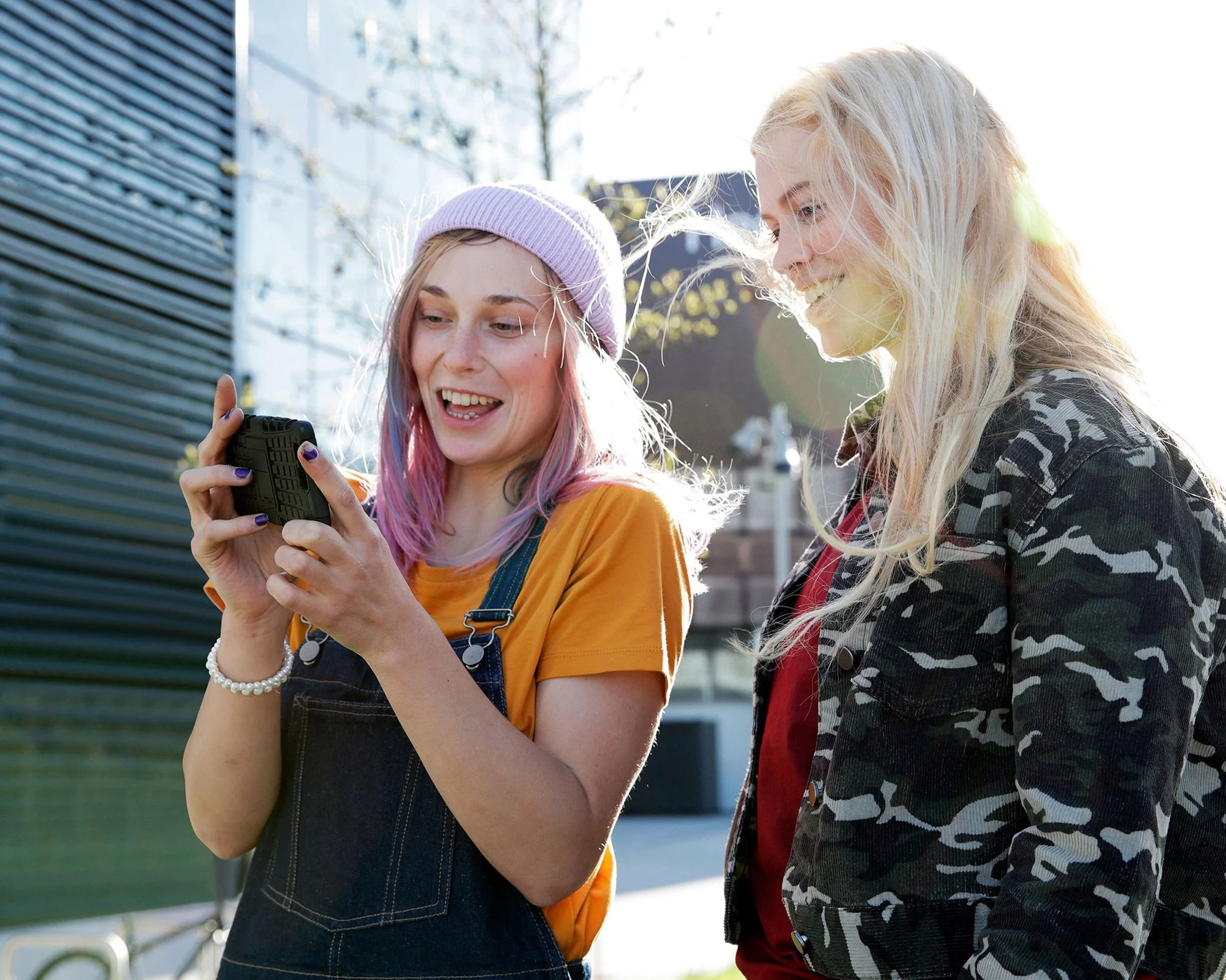 friends-looking-at-mobile-phone-together.jpg
