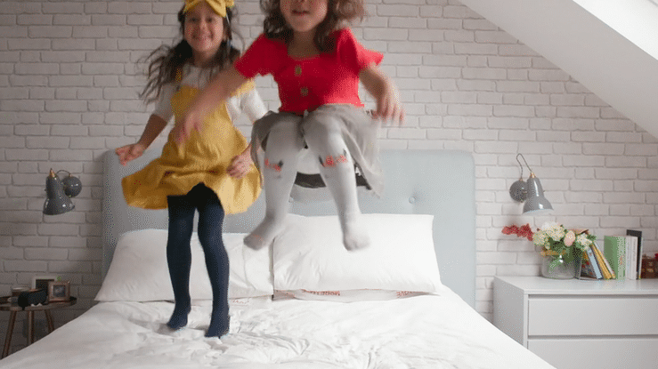 family-kids-bouncing-on-bed.gif