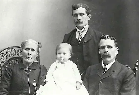 Left to right: Jane Wright Earl, Joseph Levi Earl (infant), Joseph Henry Earl (standing), and Joseph Wright Earl.