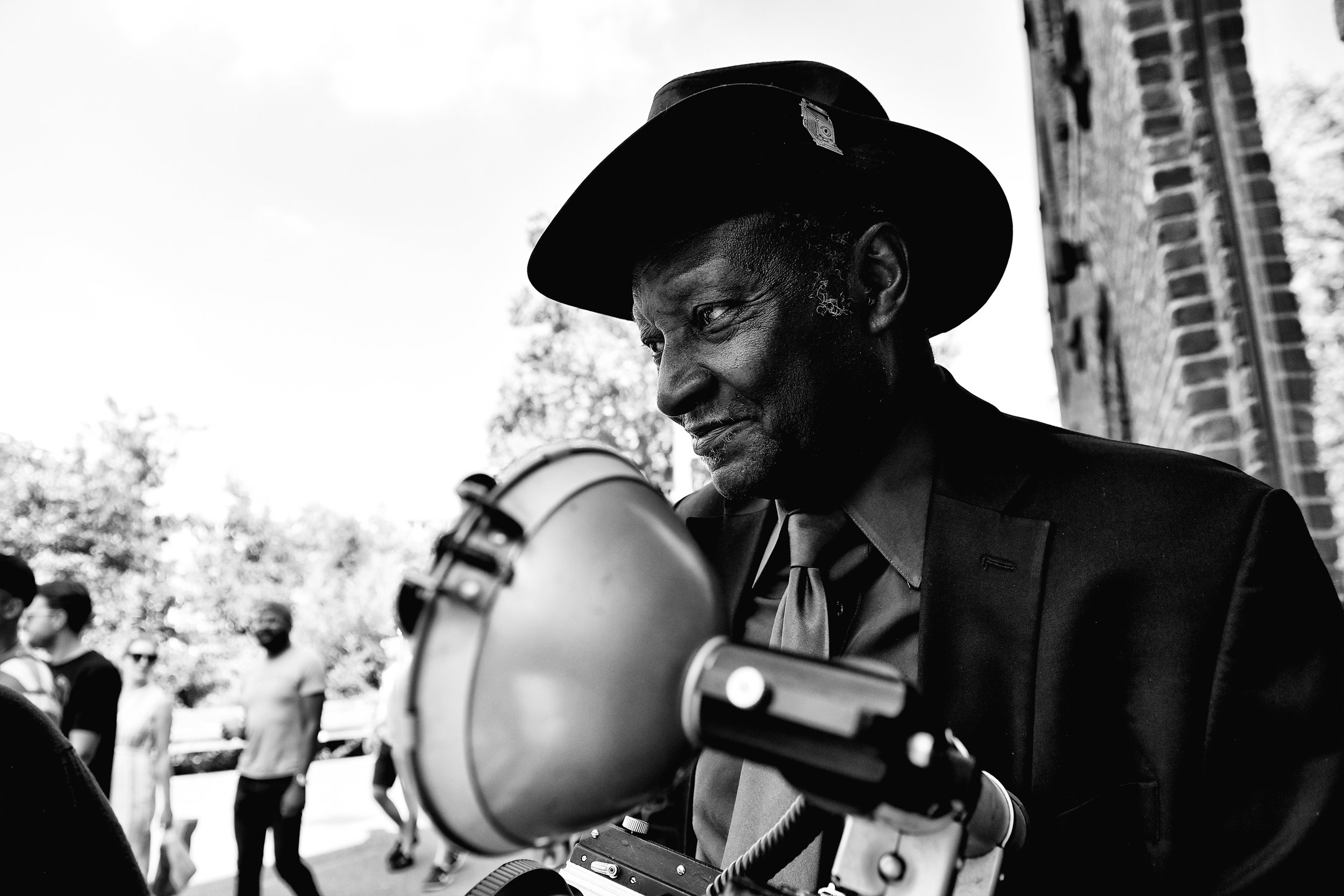  Street photographer Luis Mendes waits to take portraits of passers-by with his Speed Graphic camera near the Manhatten Bridge in Brooklyn, N.Y.  Mendes charges $20 for a Polaroid print. 