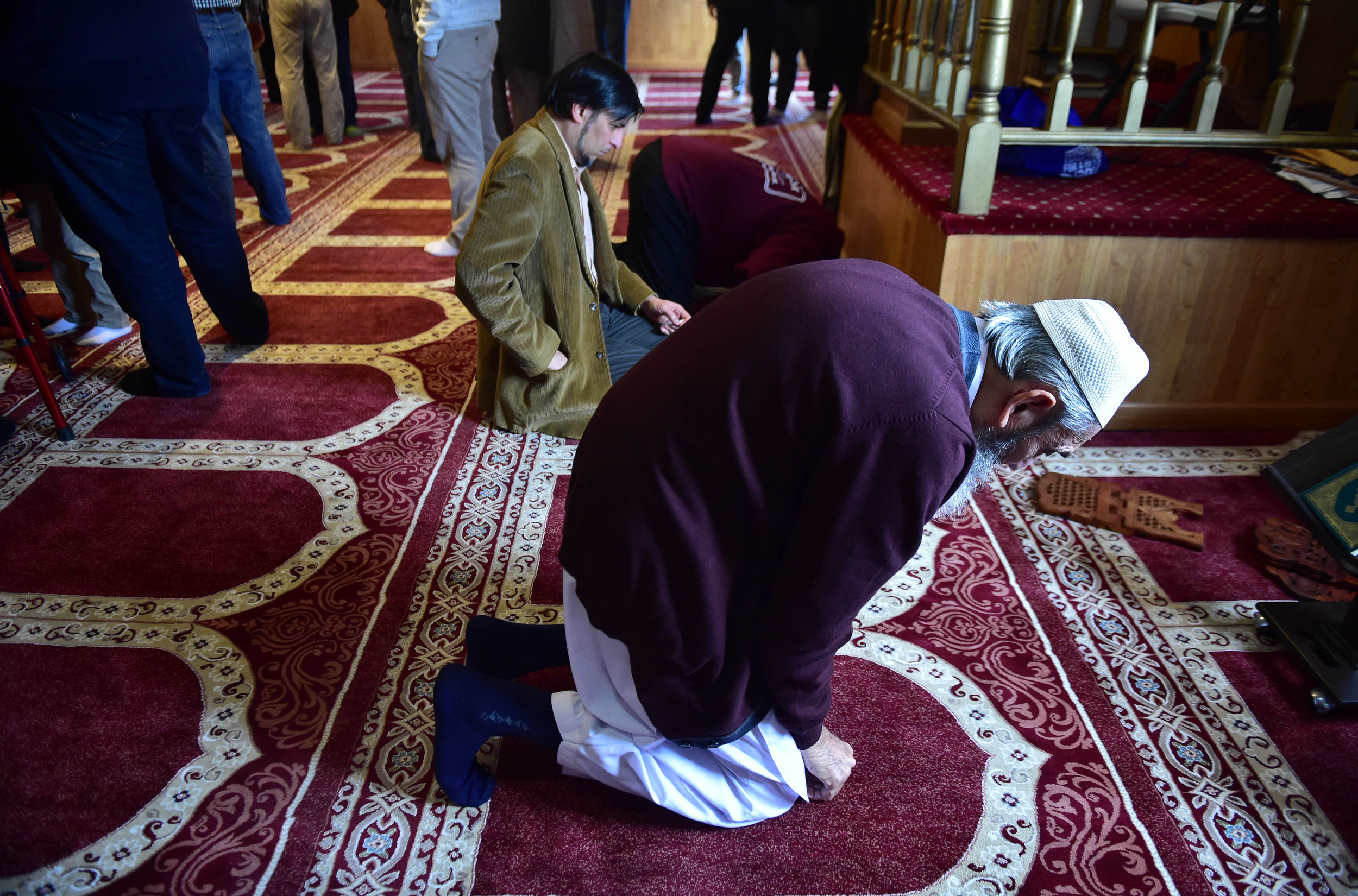 Jameel Ahmed, 81, originally from Kirachi, Pakistan, kneels to pray after the formal service in the Masjid Al-Noor mosque in Wilkes-Barre, Pa. Many local Muslims immigrated to Northeast Pennsylvania to escape political strife and conflict in their home countries and to seek a better life.