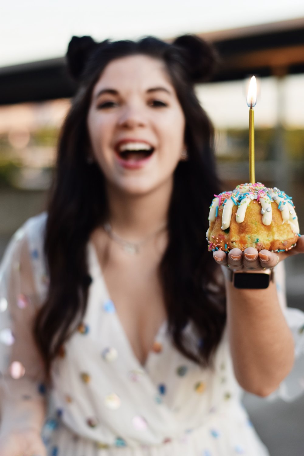 woman celebrating 26 years and holding cupcake