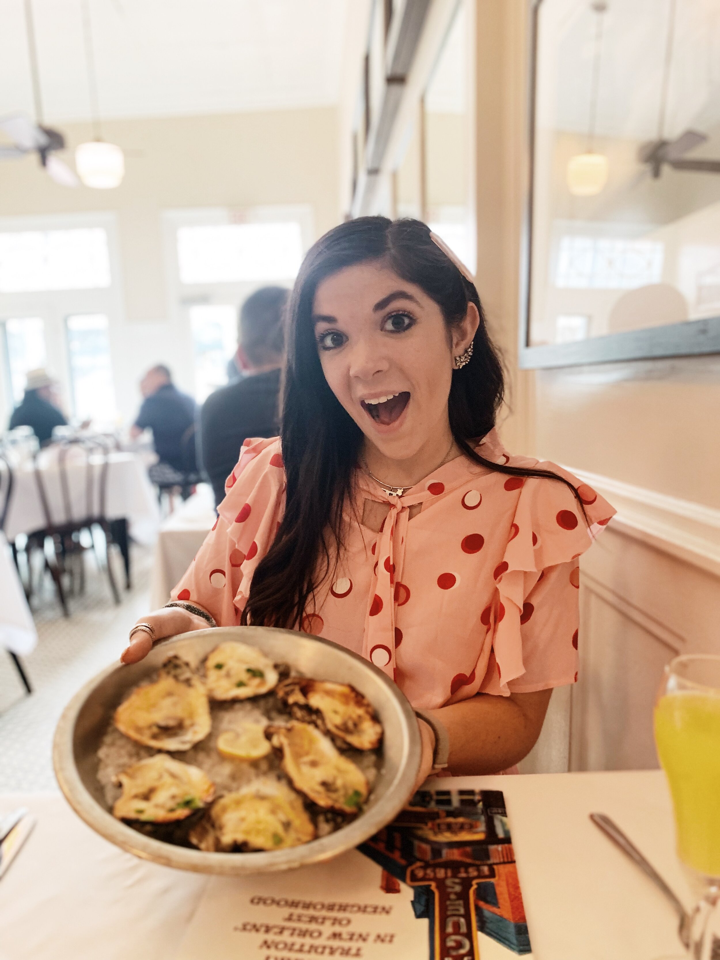 woman holding oysters in Tujague’s New Orleans in September