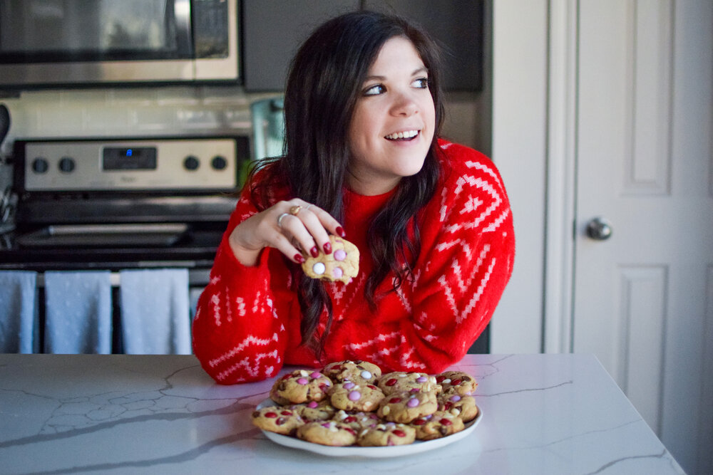 woman eating cookie and sharing M&amp;M COOKIE RECIPE