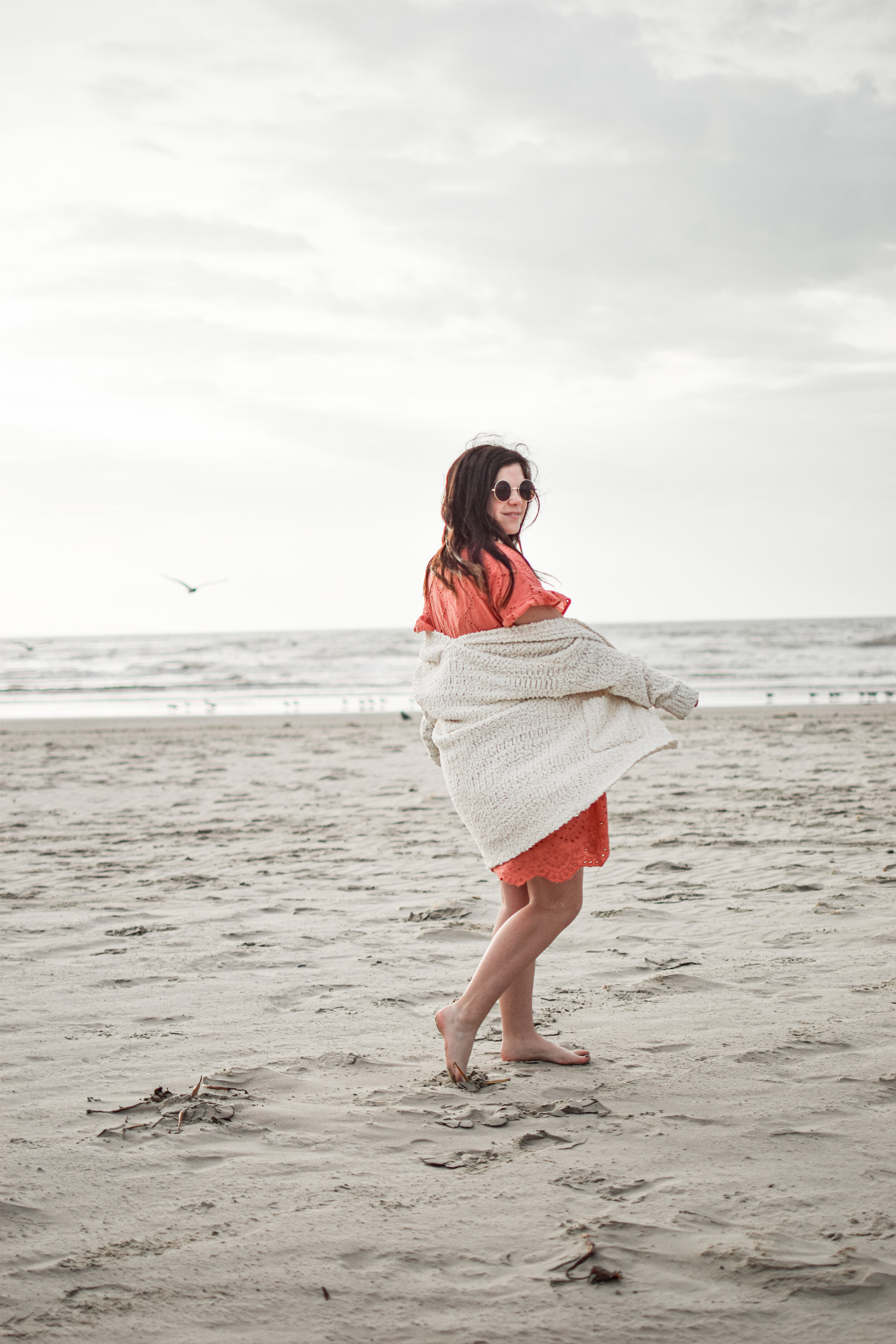 woman at the beach in sweater