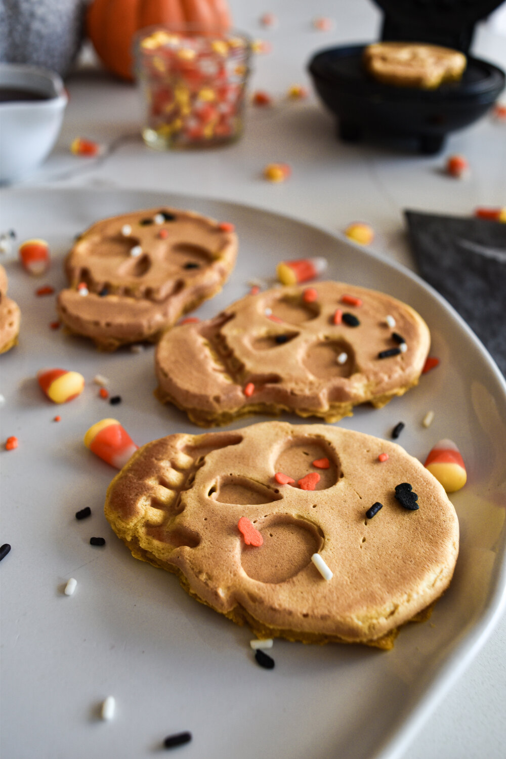 skull waffles on a white plate with sprinkles 
