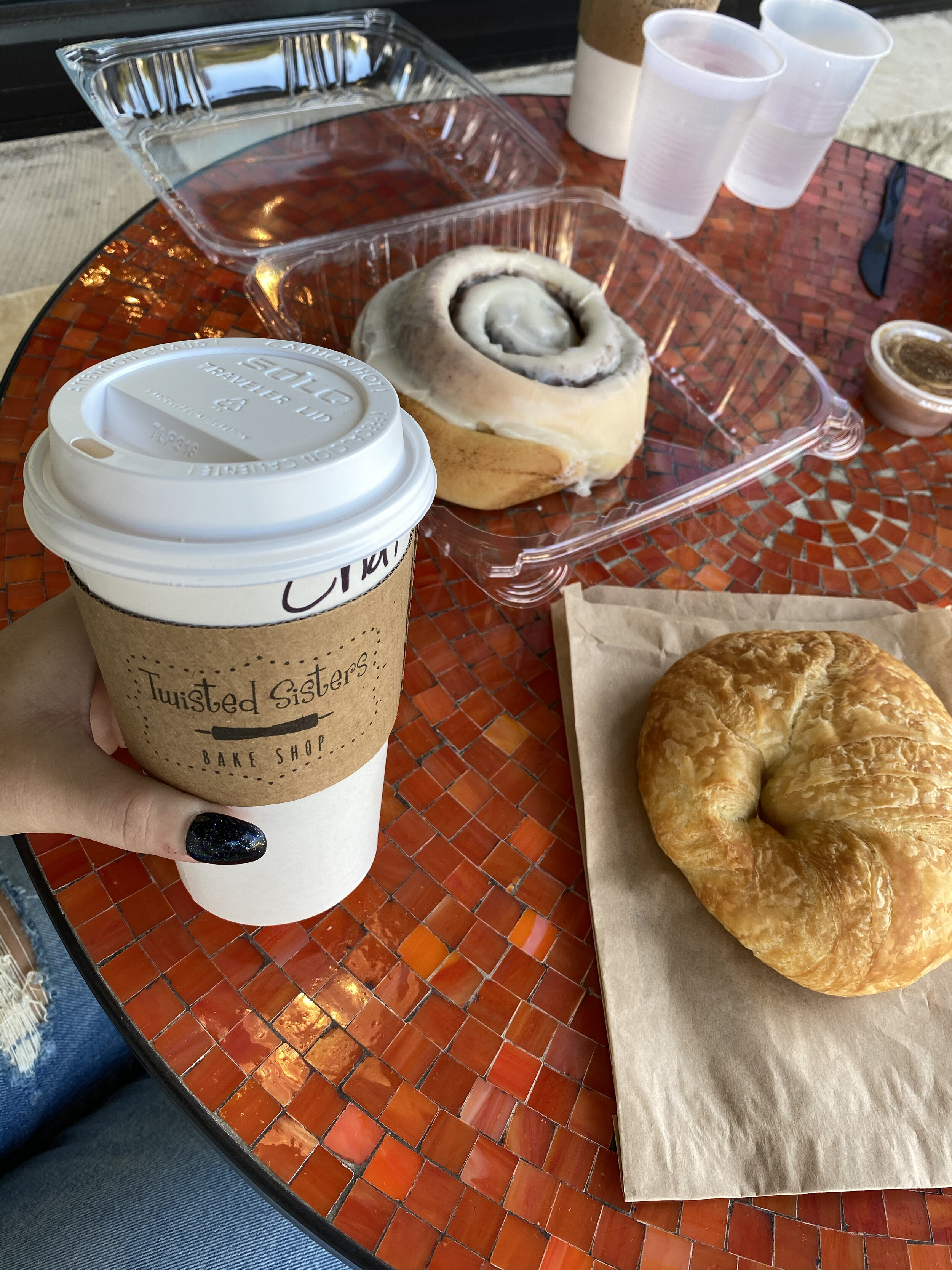 a cup to-go with bread on a table