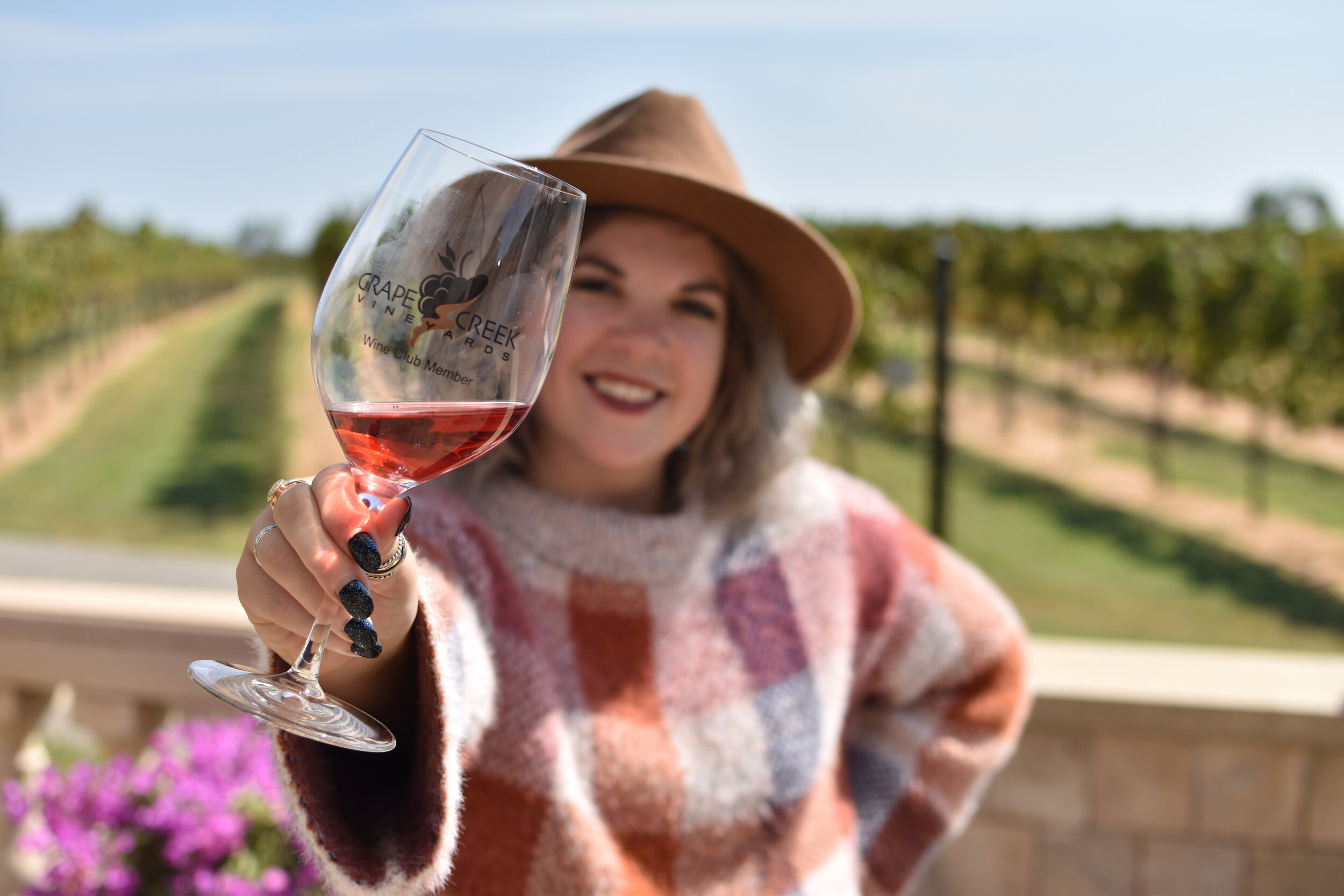 woman holding a wine glass at the Grape Creek Vineyards