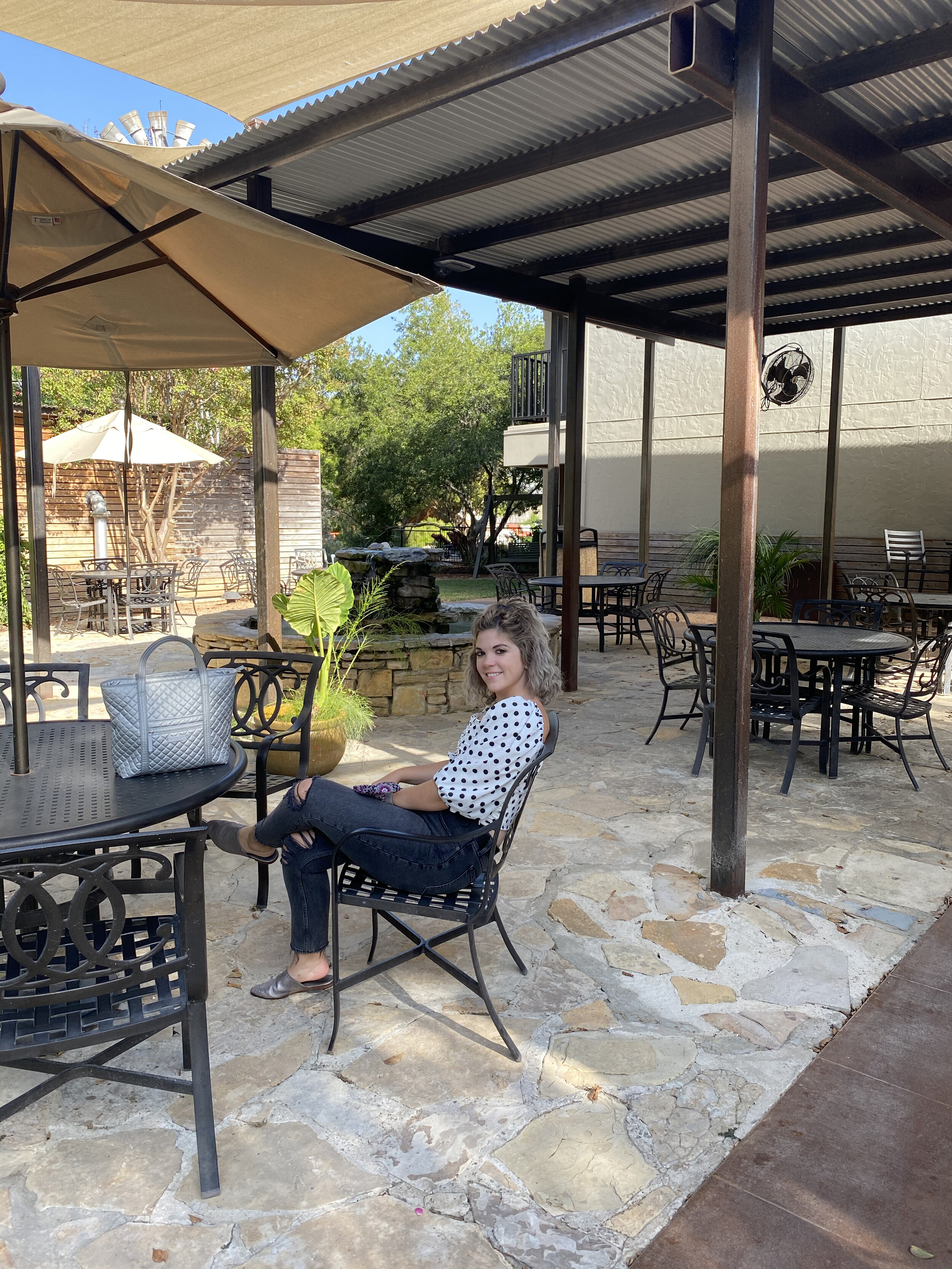 woman sitting at an outdoor cafe