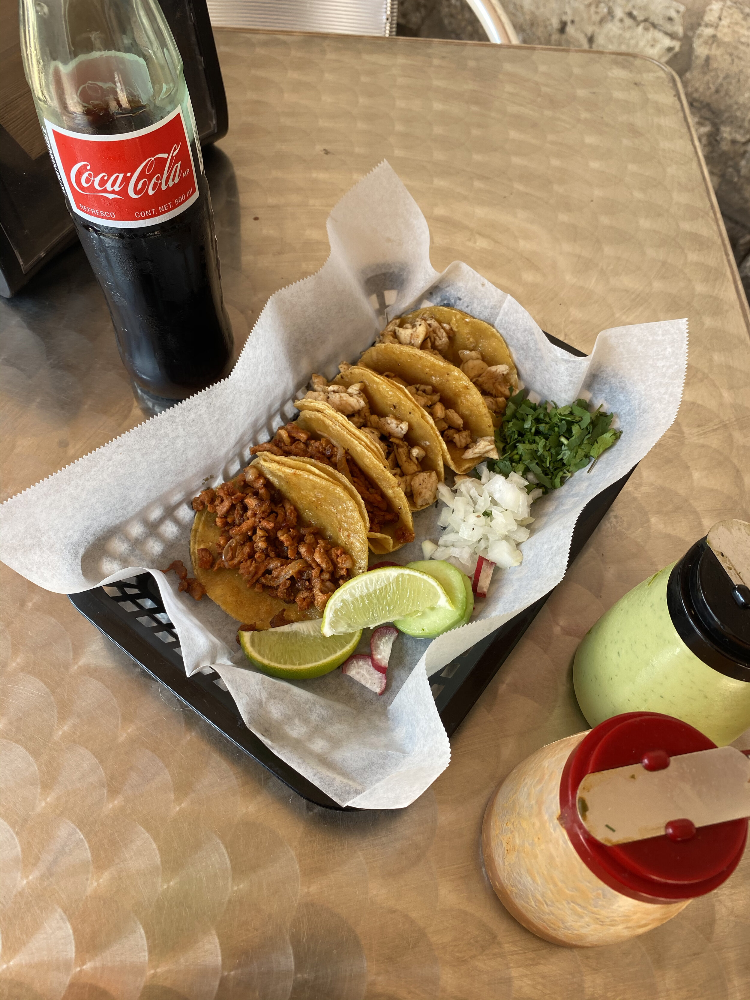 tacos and coca cola on a table