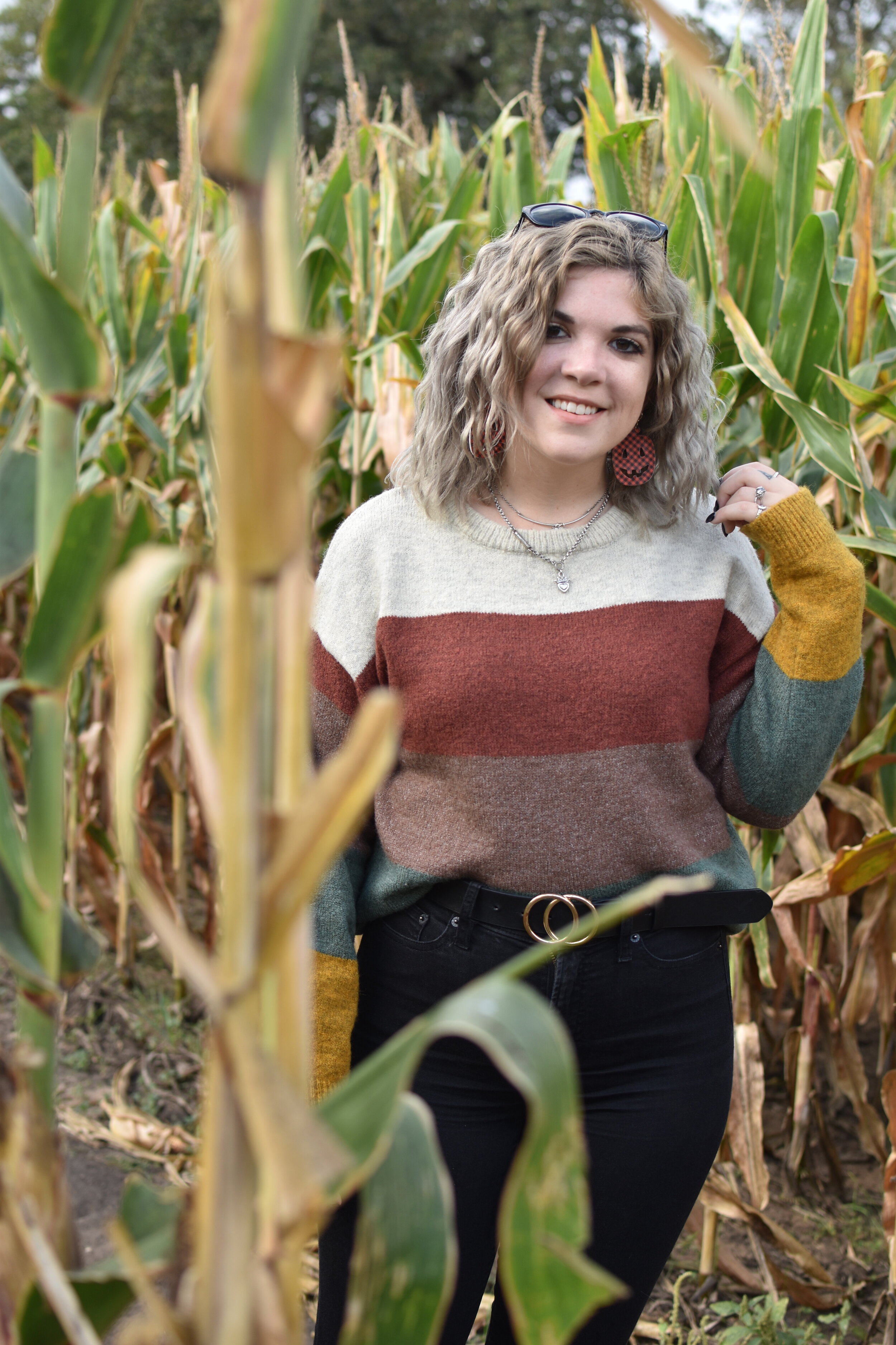 woman posing and taking a photo at the cornfield 