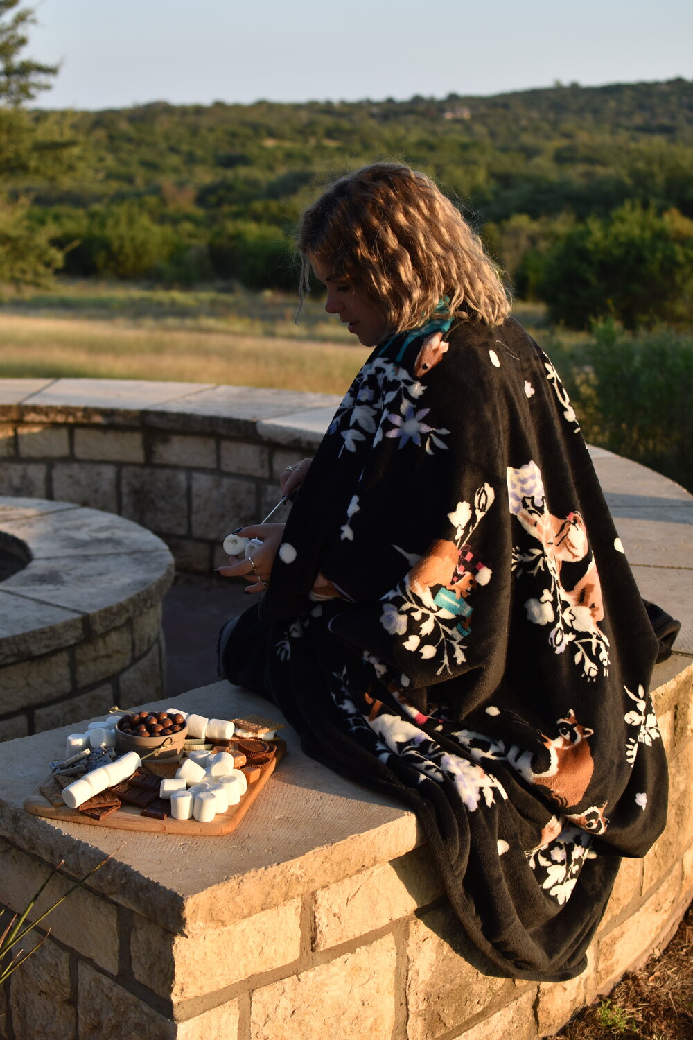 woman sitting in outdoor fire pit