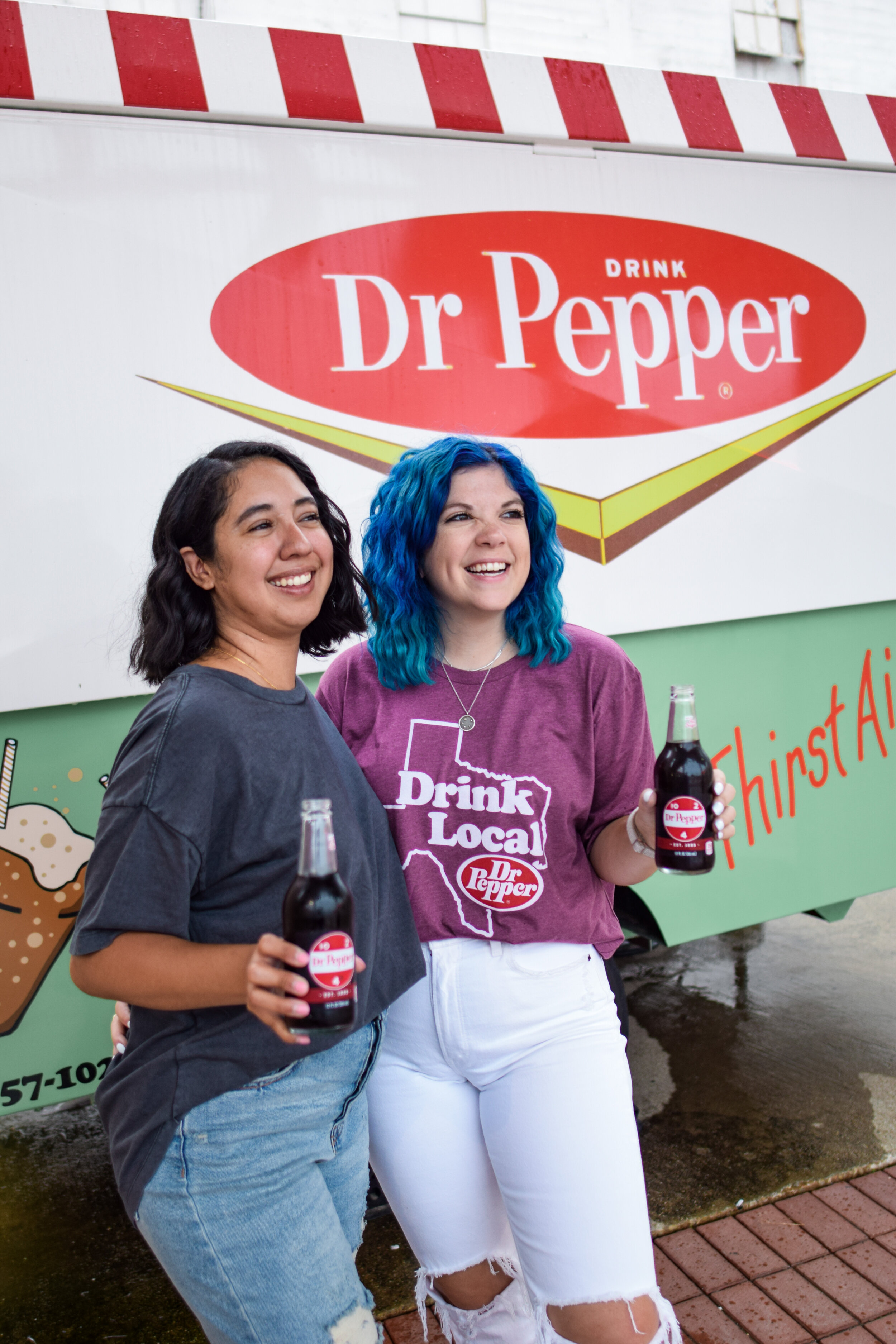 two women holding dr. pepper