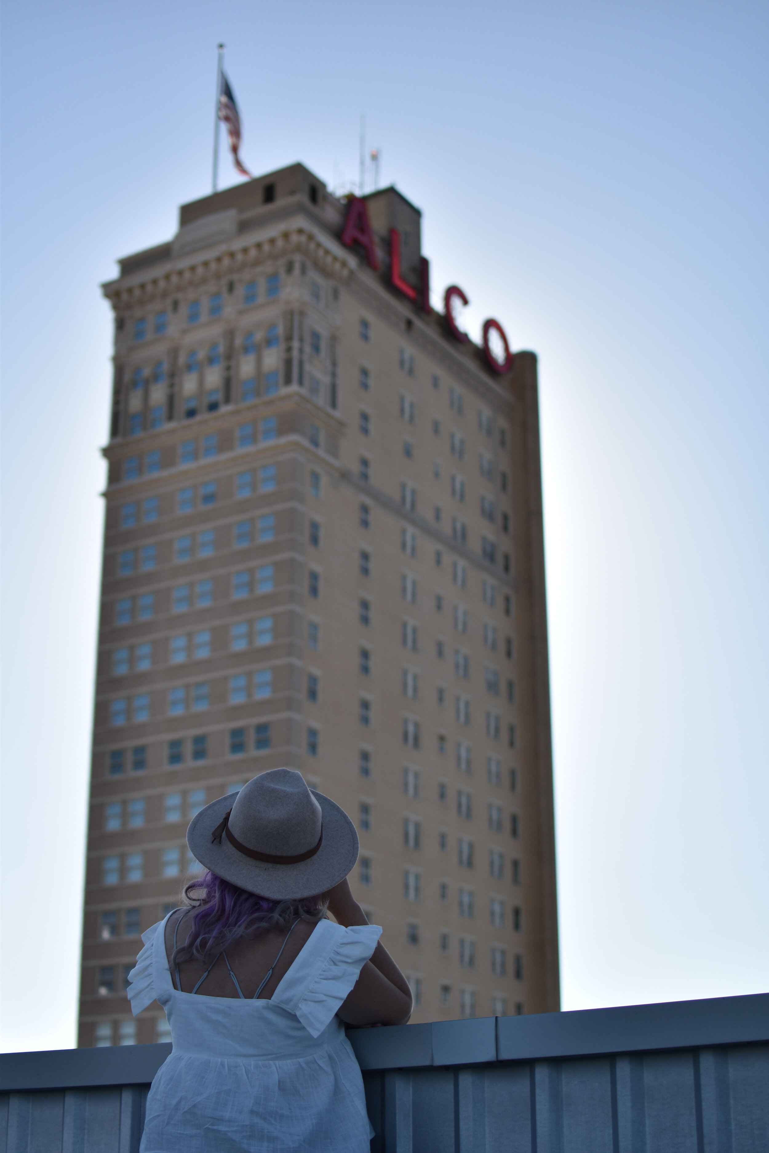 woman looking up at the ALICO building