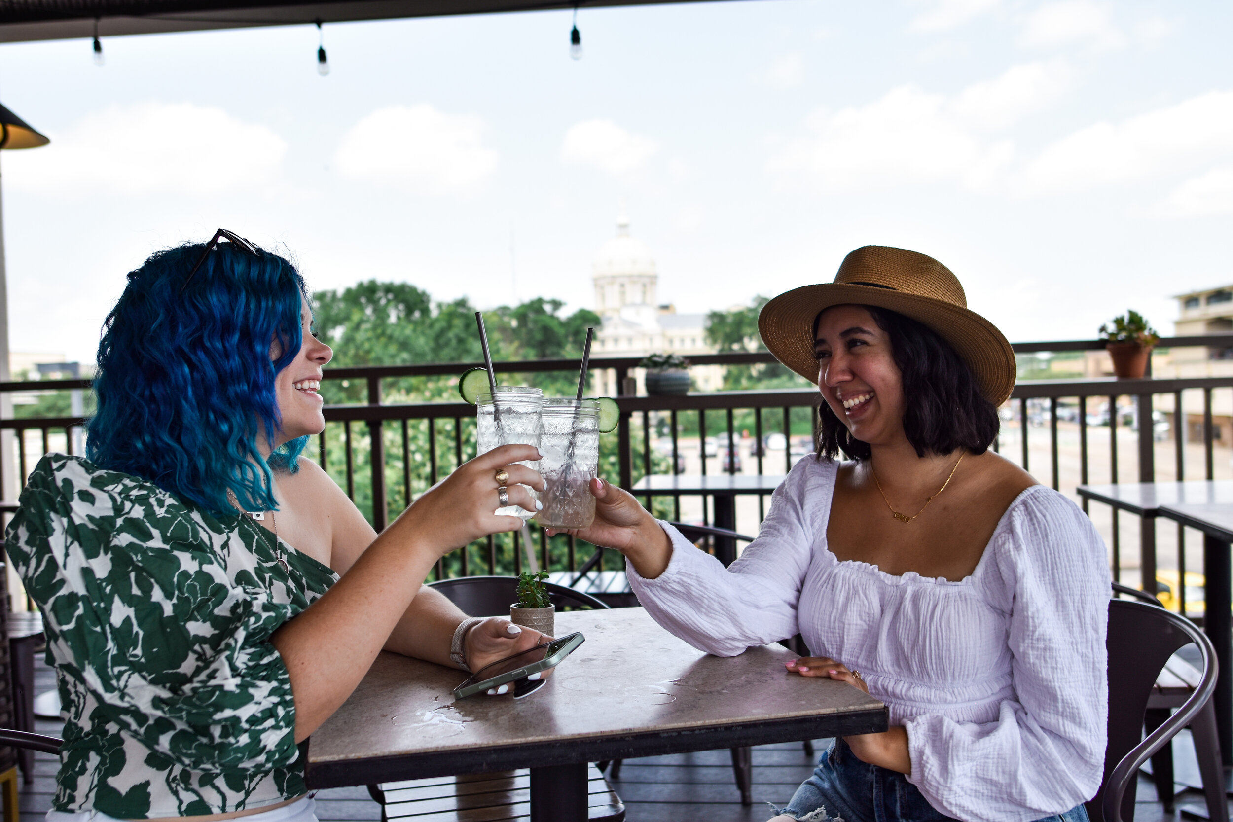 woman with blue green hair holding a drink at Dichotomy, Waco, Texas