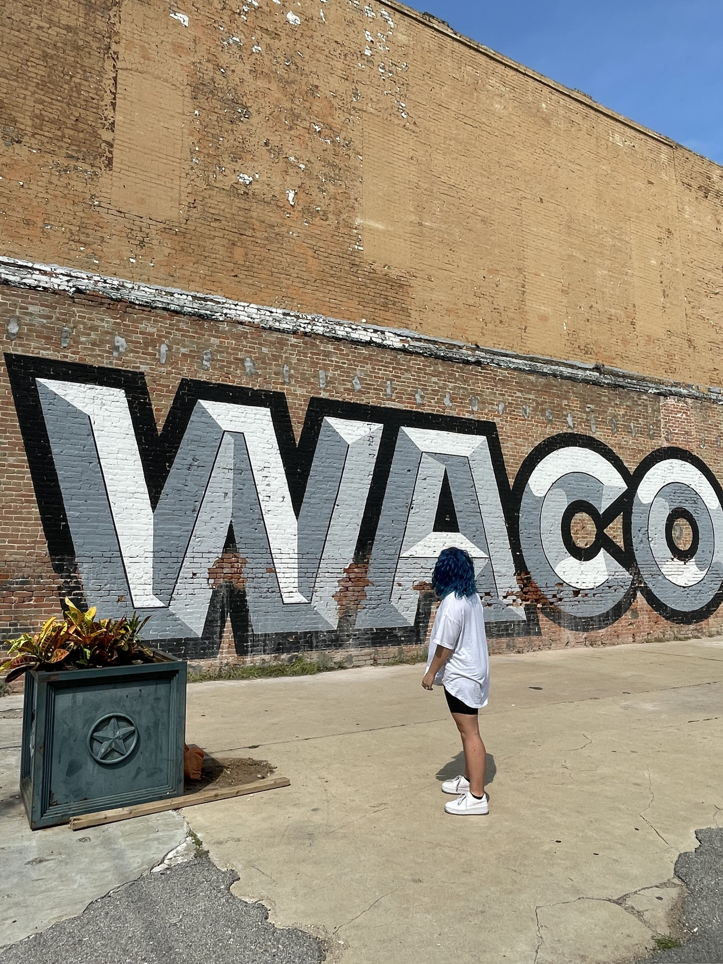 woman standing with Bold Waco behind her