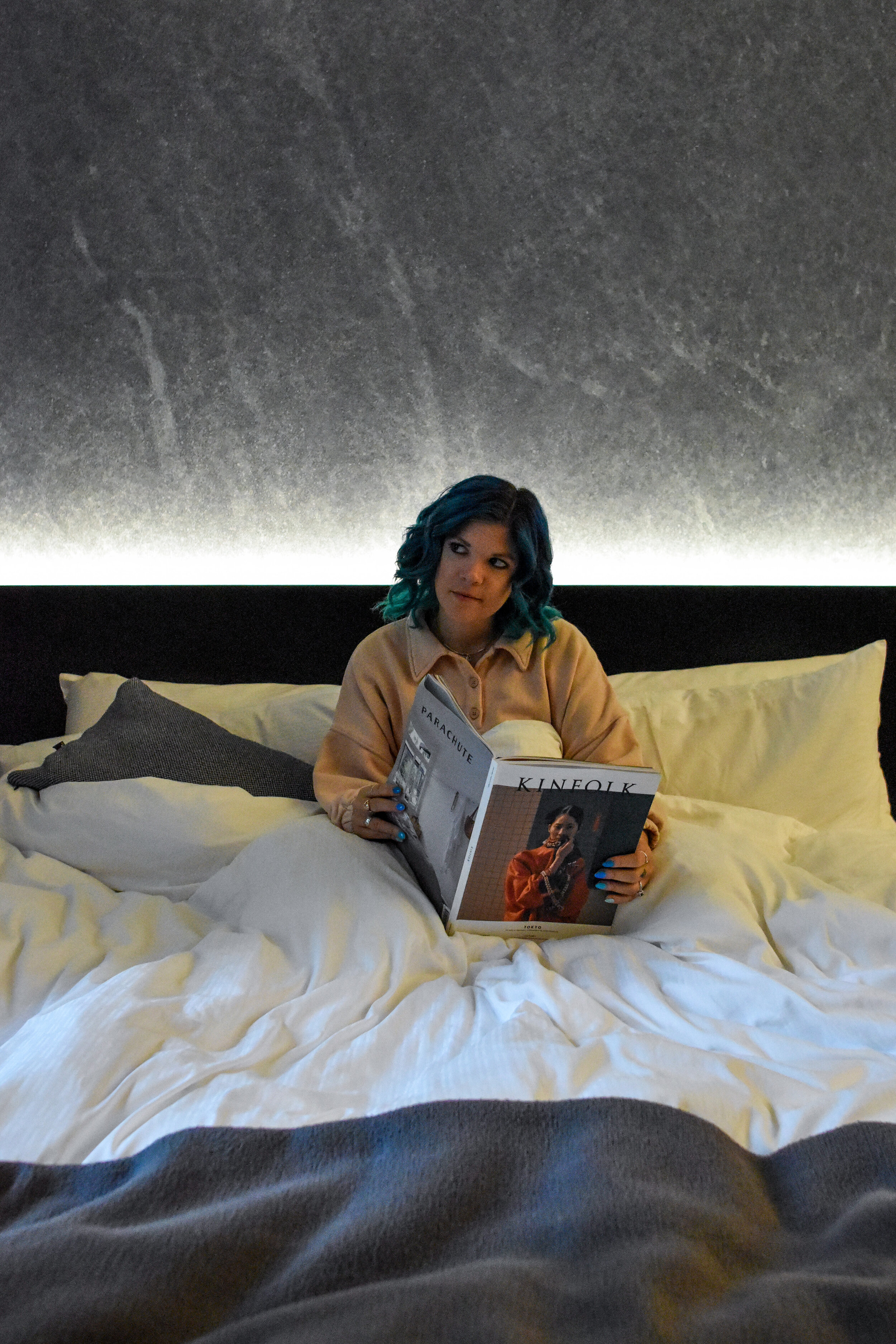 woman in bed in  apartment style hotel in new york