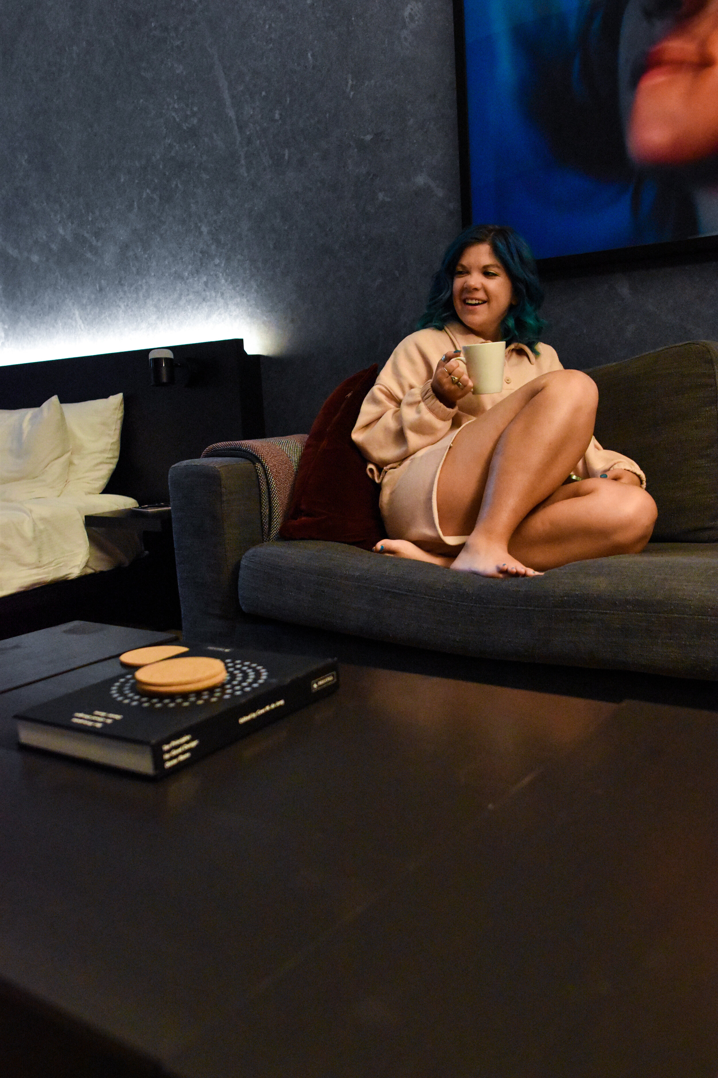 woman sitting in couch in  apartment style hotel in new york