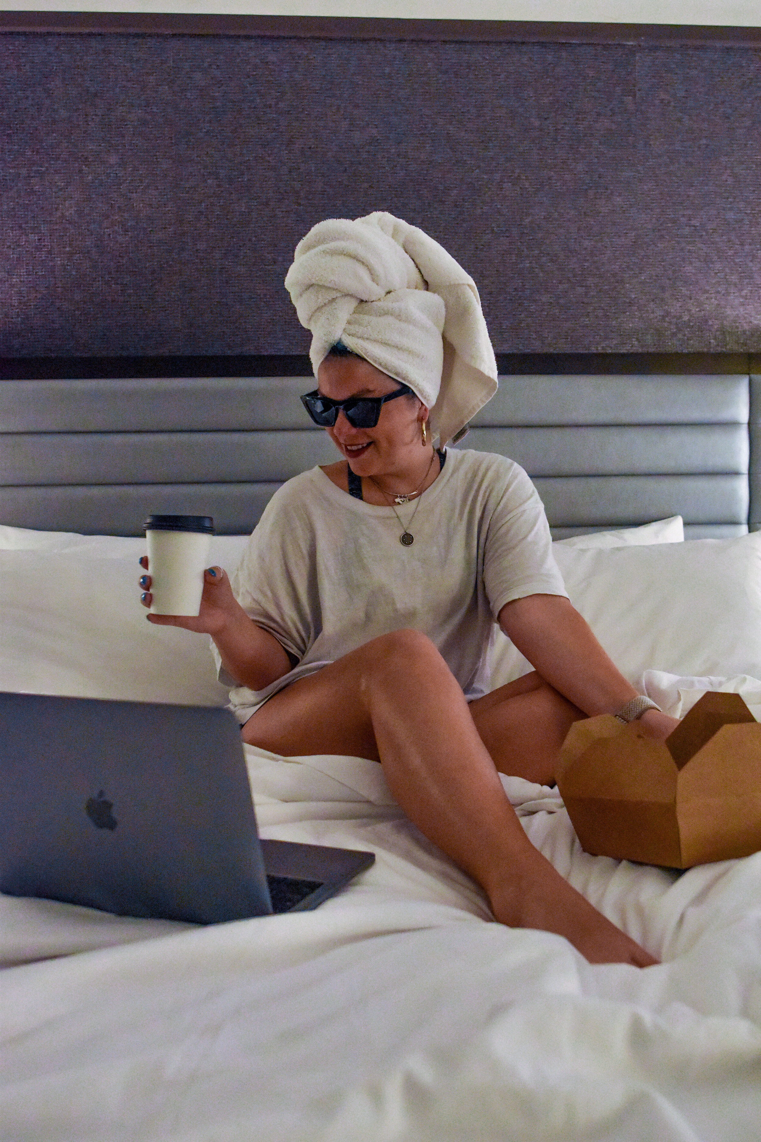 woman sitting on a bed at the PARK CENTRAL HOTEL