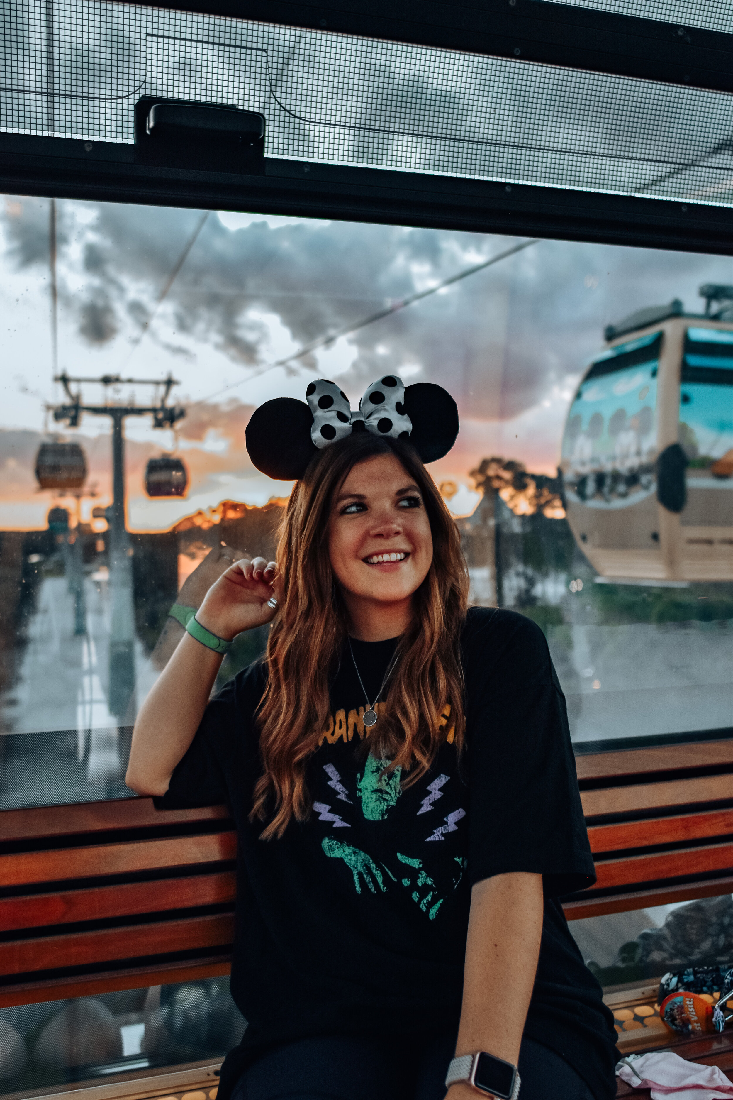 woman wearing black shirt and mickey mouse headband celebrating Halloween at Disney World