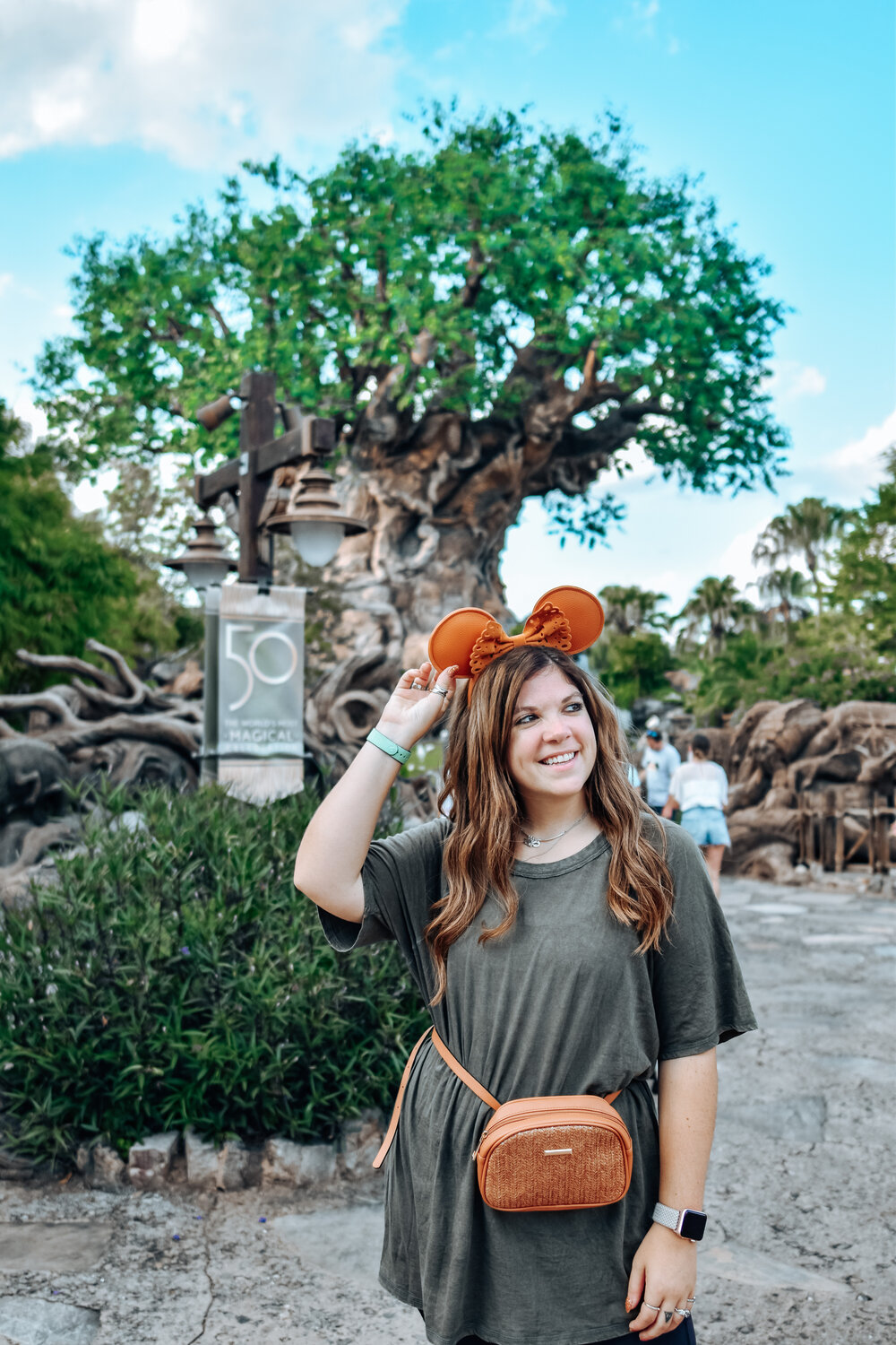 woman in safari ride and wearing shirt dress and animal ears headband 