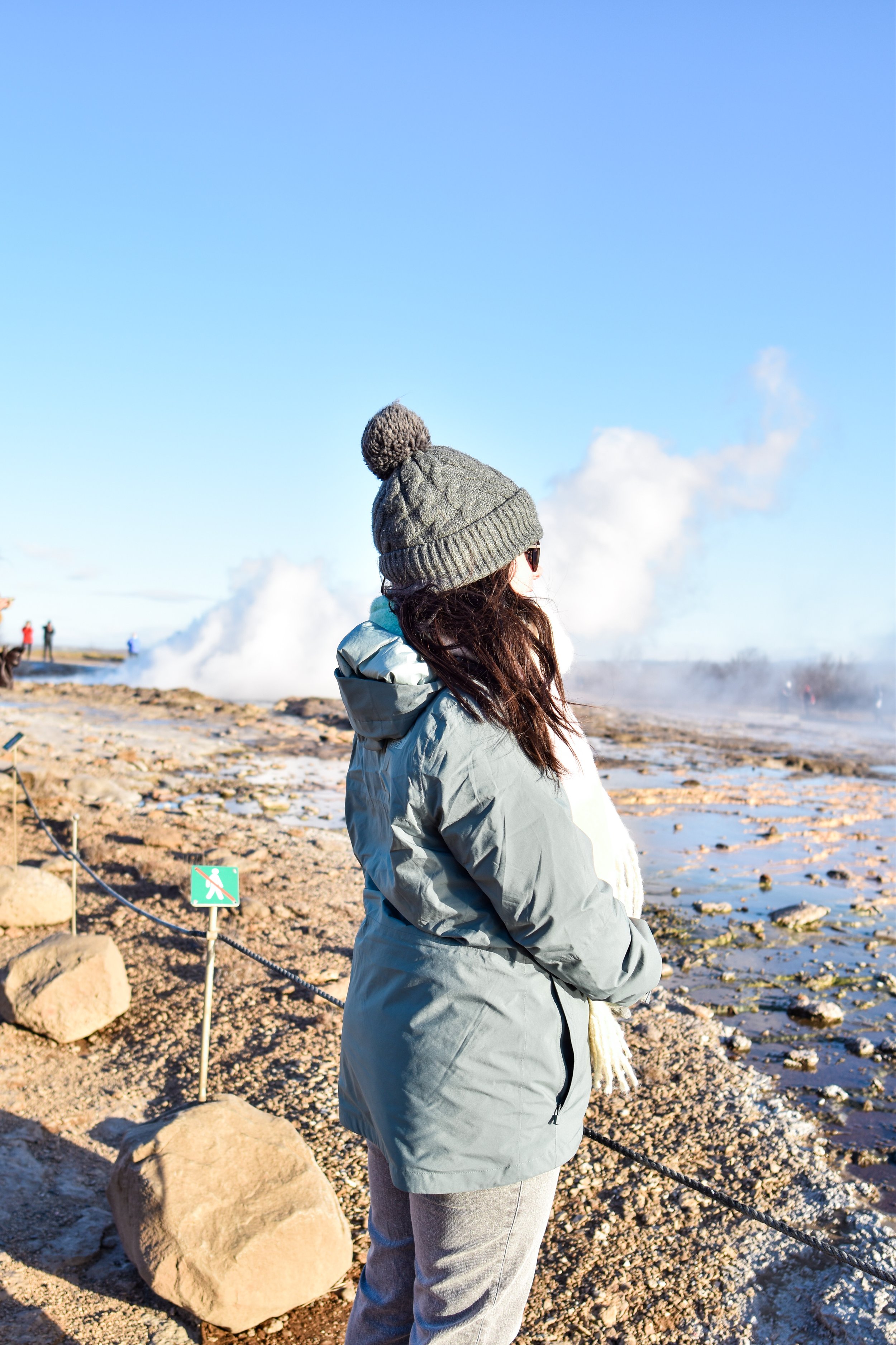 woman looking at the Geysir Hot Spring Area