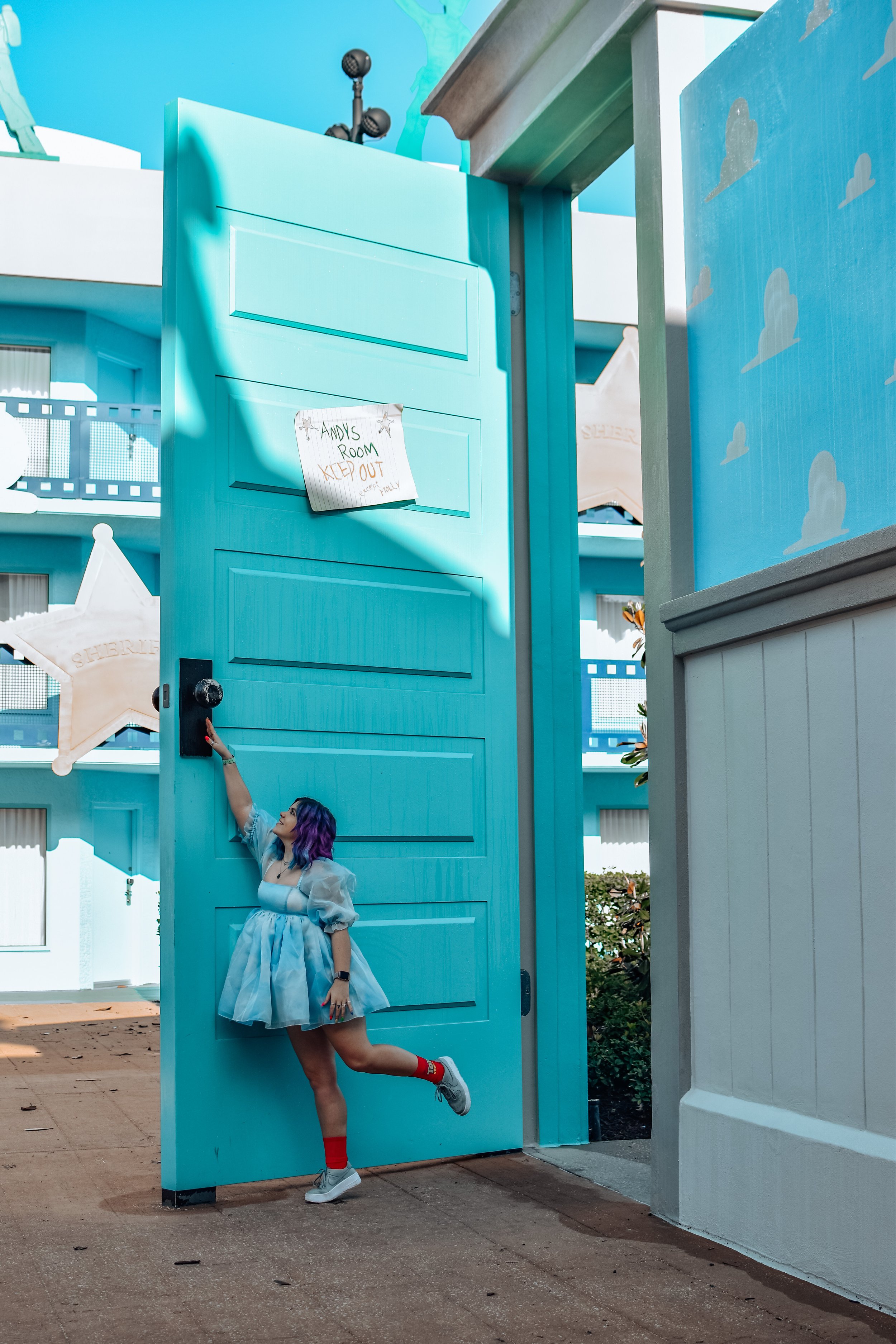 woman at disney's all-star movies resort with big door 