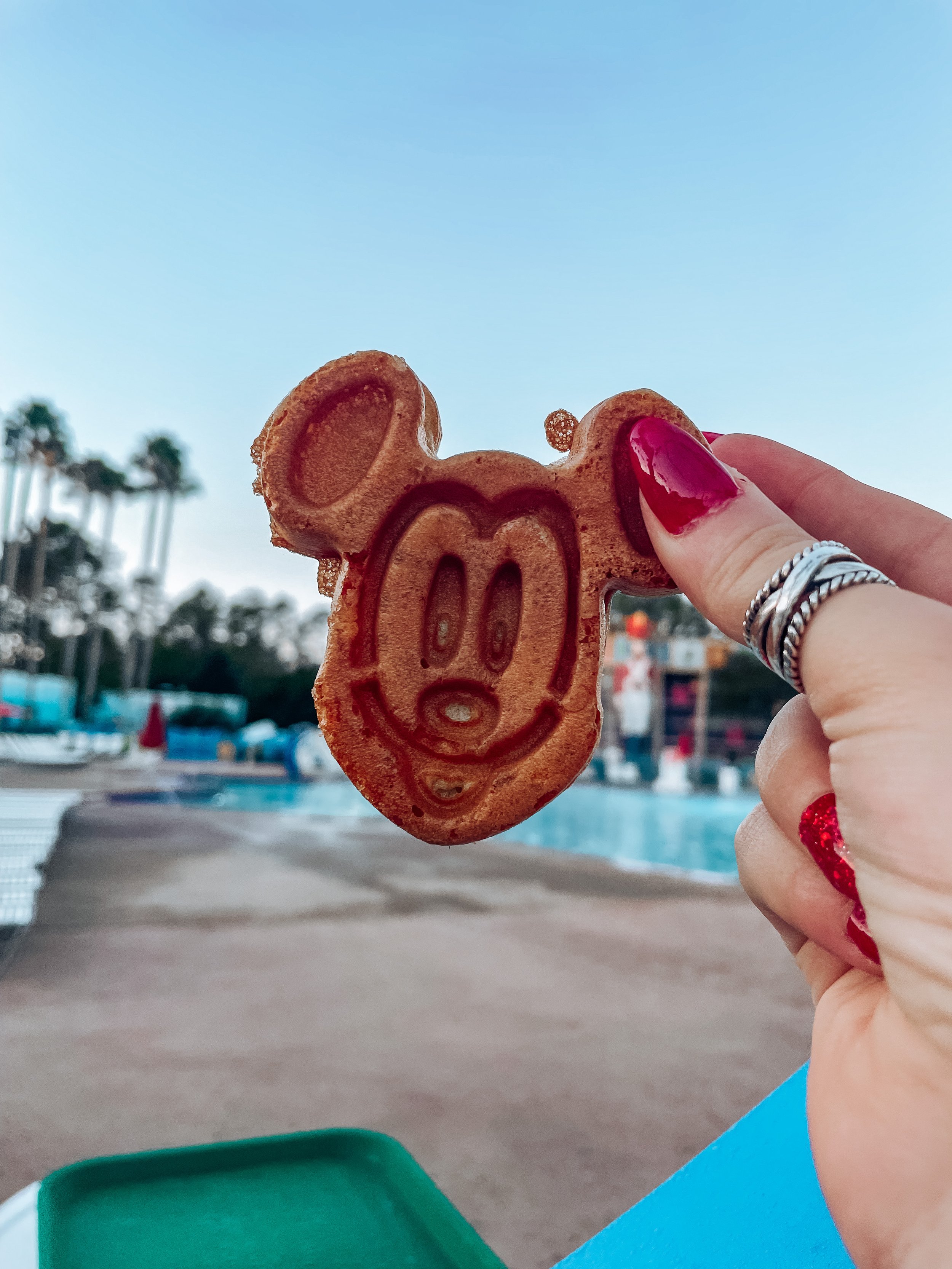 woman holding mickey cookie 