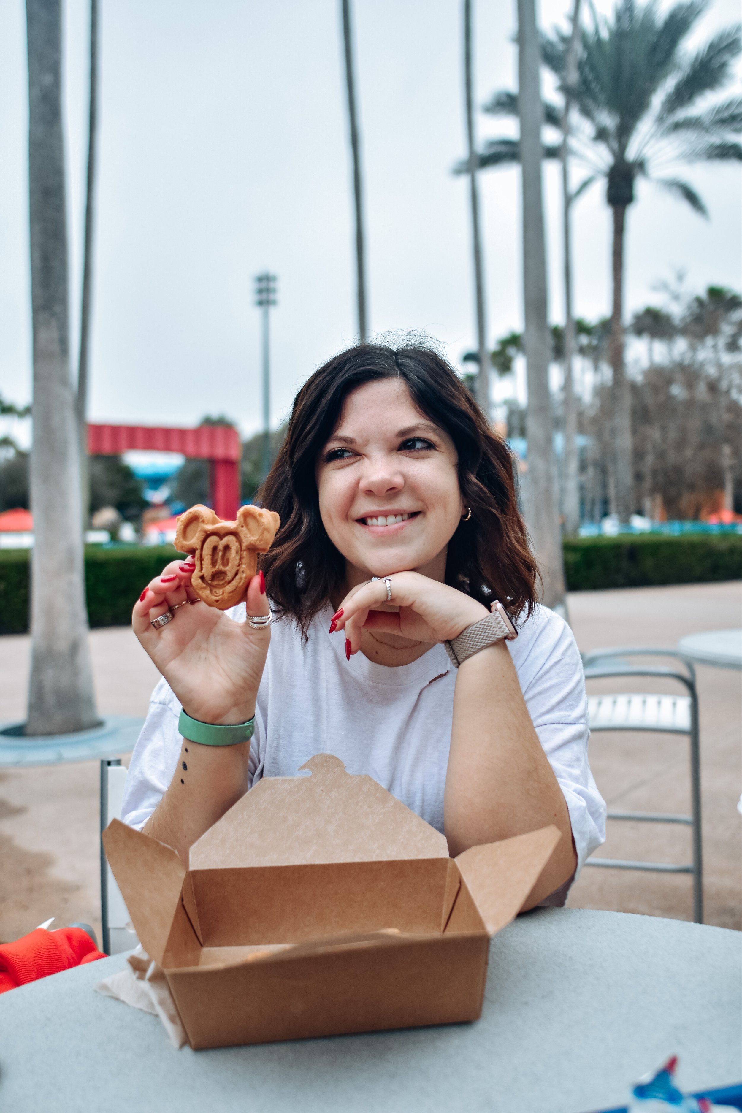 woman eating mickey cookie 