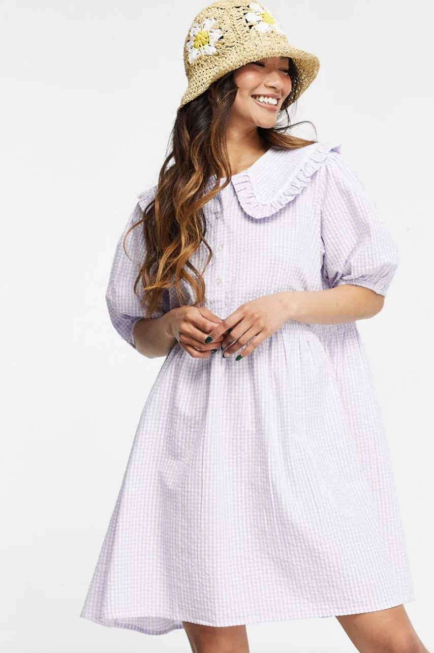 woman in white dress and bucket hat