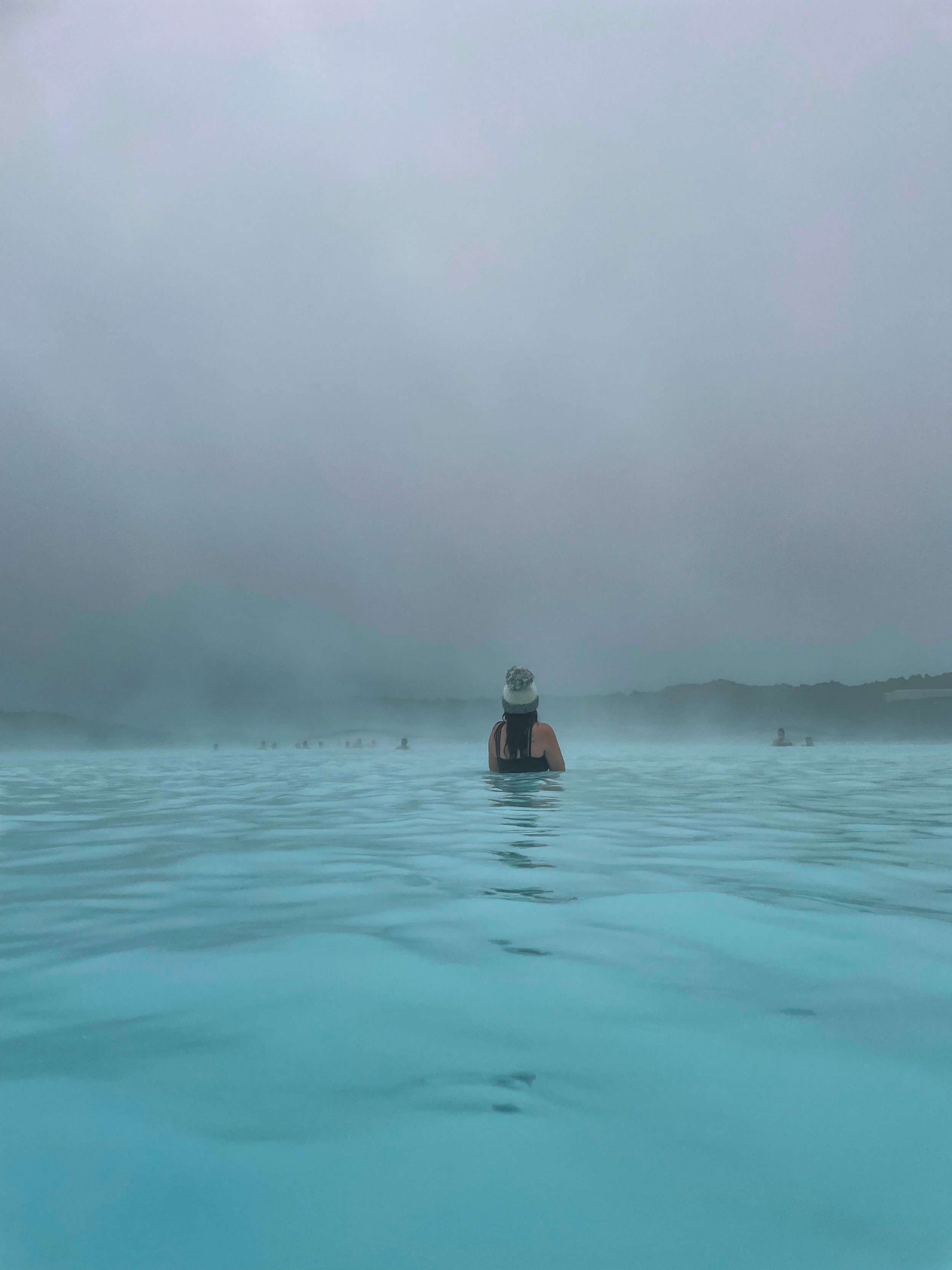 woman taking a dip at BLUE LAGOON IN ICELAND