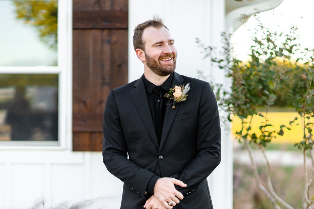 groom in all black suit