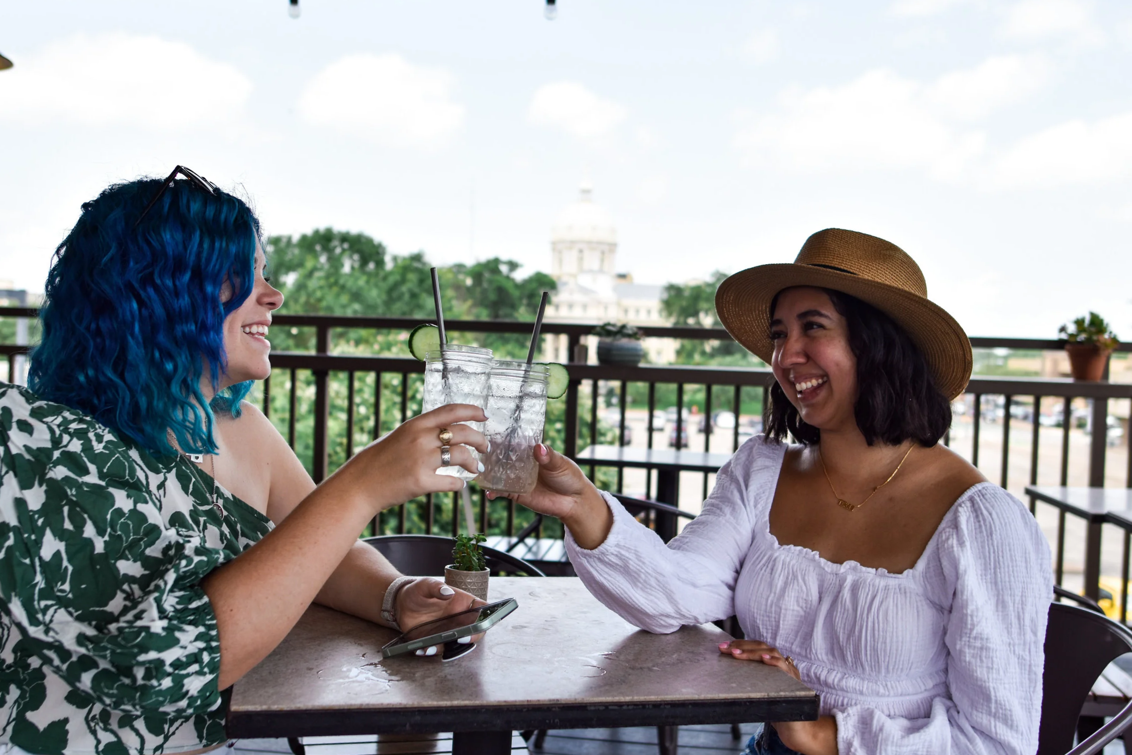 woman with blue green hair holding a drink at Dichotomy, Waco, Texas