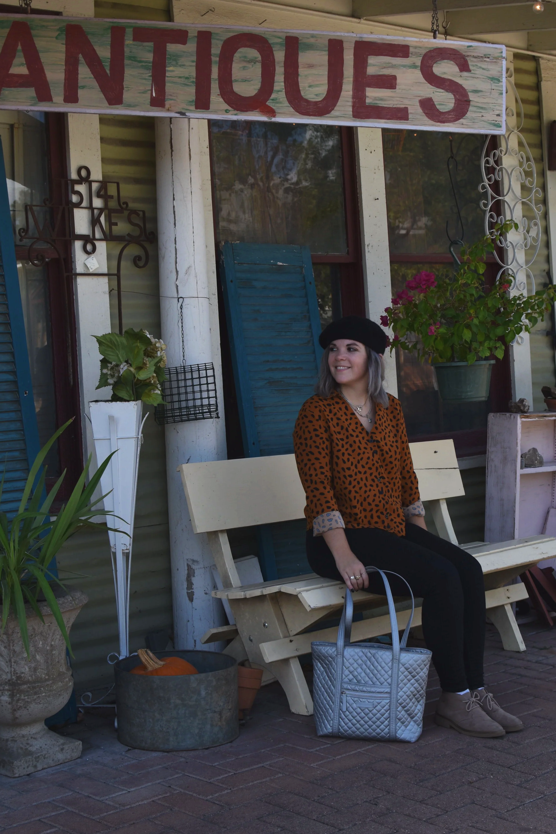 woman sitting on a wood bench for for one day guide to Georgetown