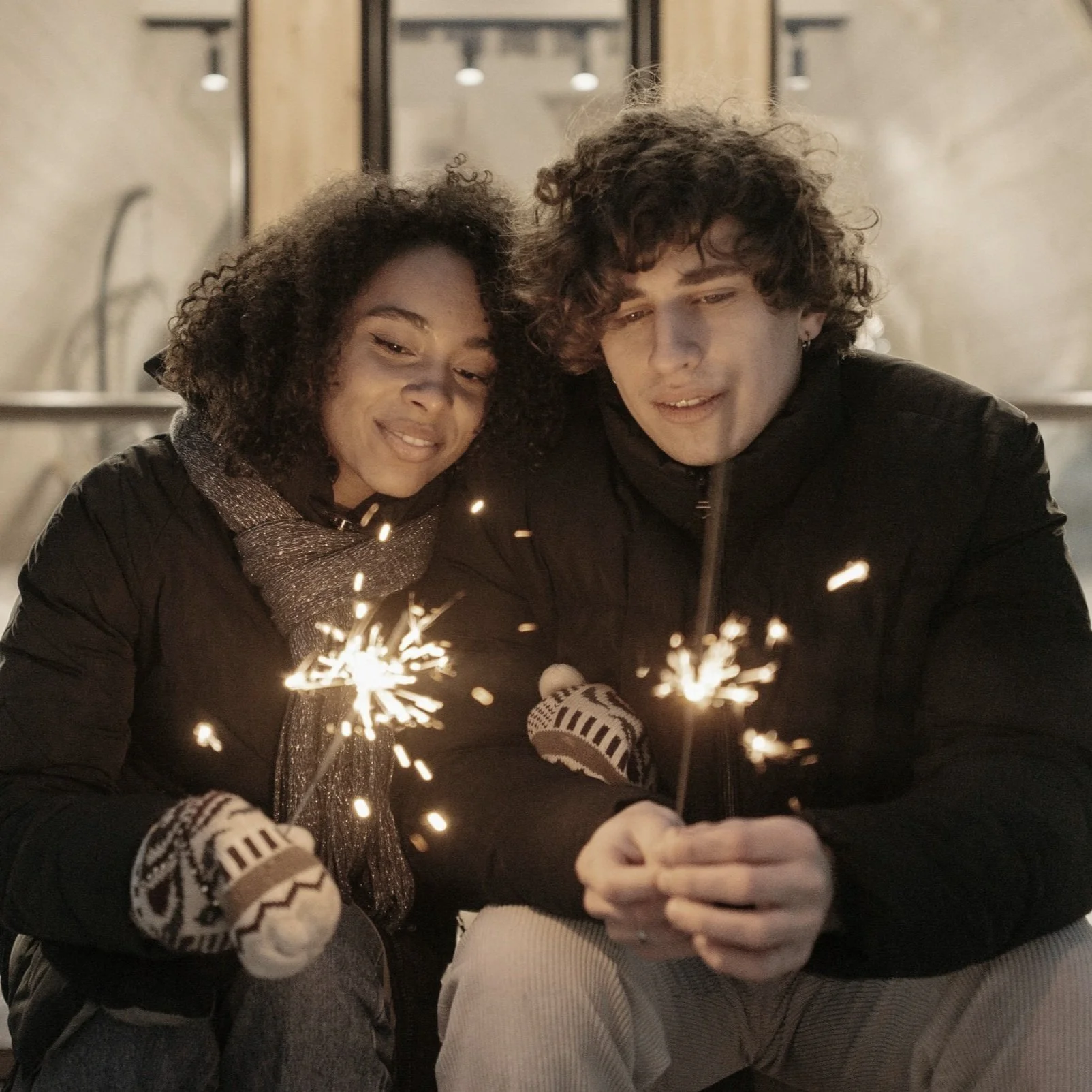 An interracial couple close together using sparklers after Christian counseling