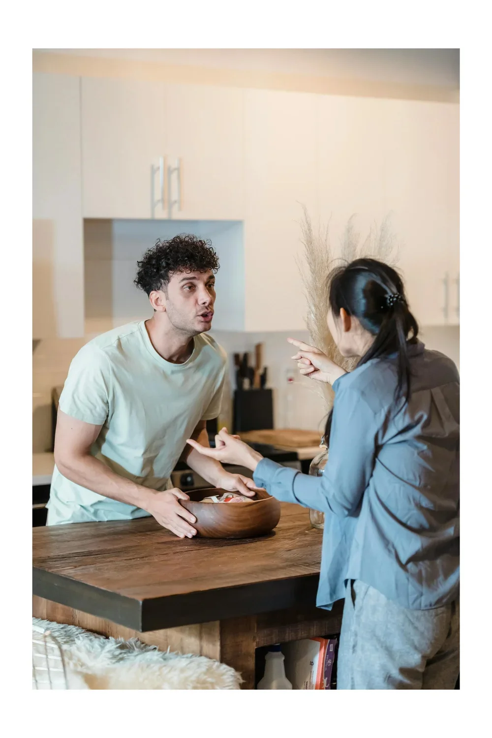 An interracial couple arguing in their kitchen in Houston, Texas