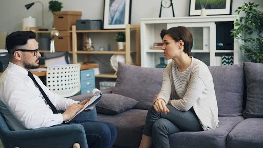 Woman talking with a counselor during a therapy session, representing culturally competent mental health counseling in Texas