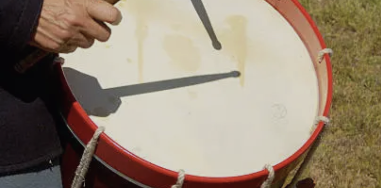 Drummer beating drum for communications