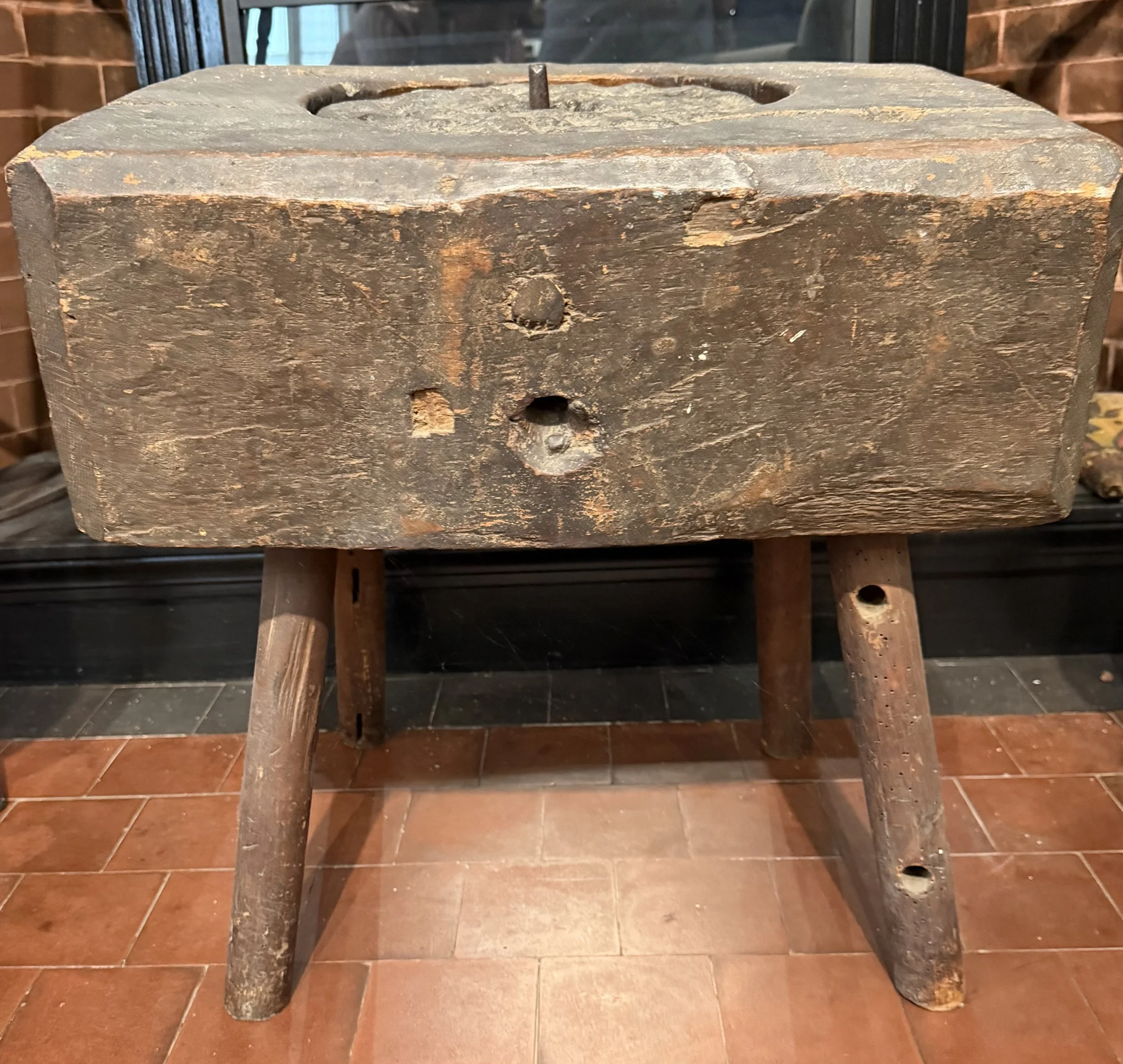 Hand grist mill used early 1600s in Massachusetts Bay Colony when towns didn't have water powered grist mills. The leggs have been added top stone and handle missing