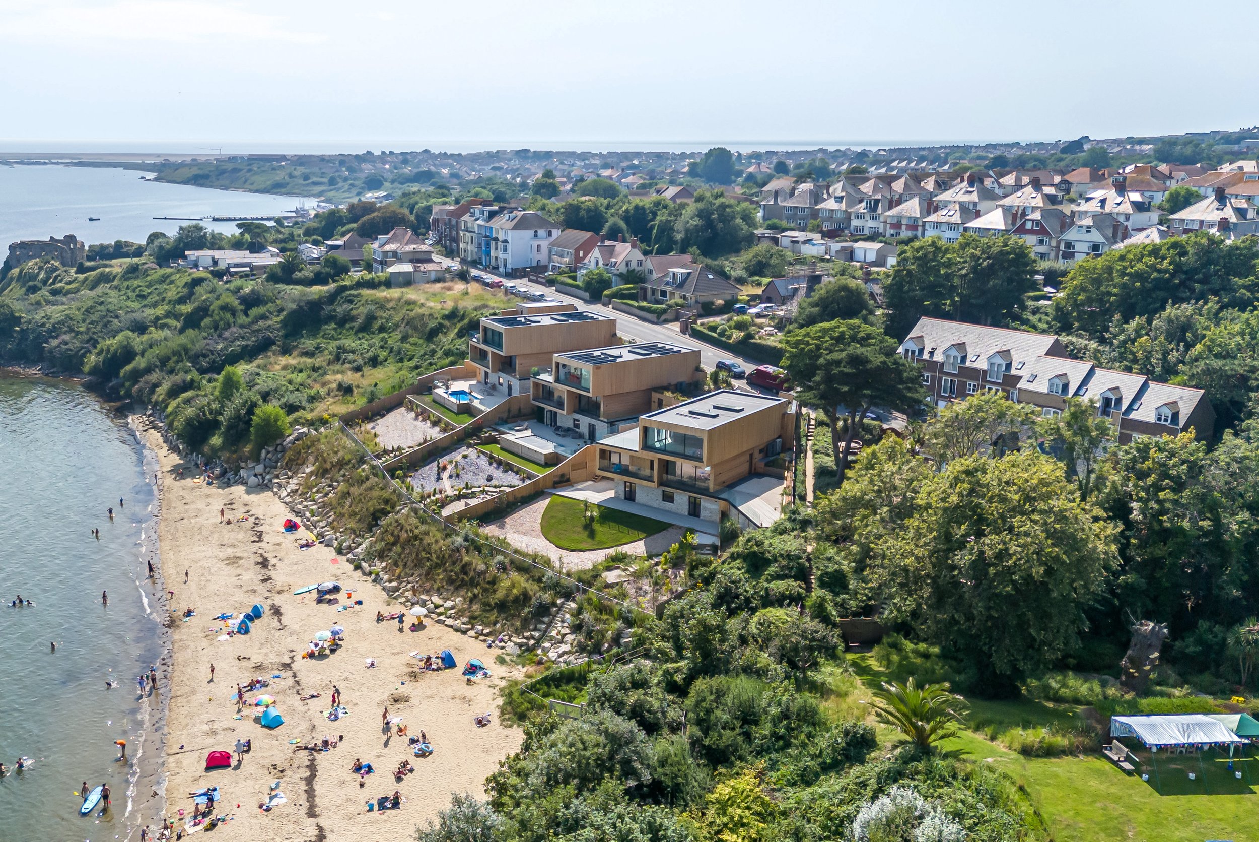 In a secluded corner of Dorset, where the land meets the sea and the rugged cliffs of the Jurassic Coast unfold, a site once abandoned and overgrown has been transformed into a stunning trio of bespoke homes. Nestled above Portland Harbour, these re