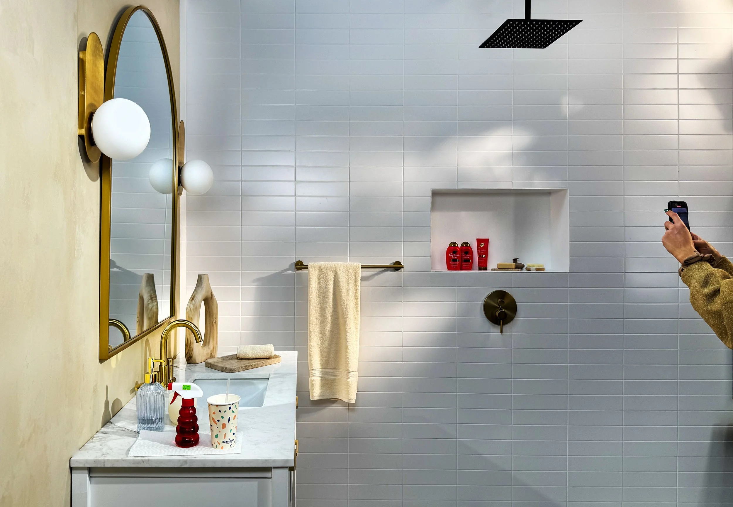 Ground Level Studio - Stacked White Tile Shooting Bathroom with Working Showers - A diverse array of shower heads are available