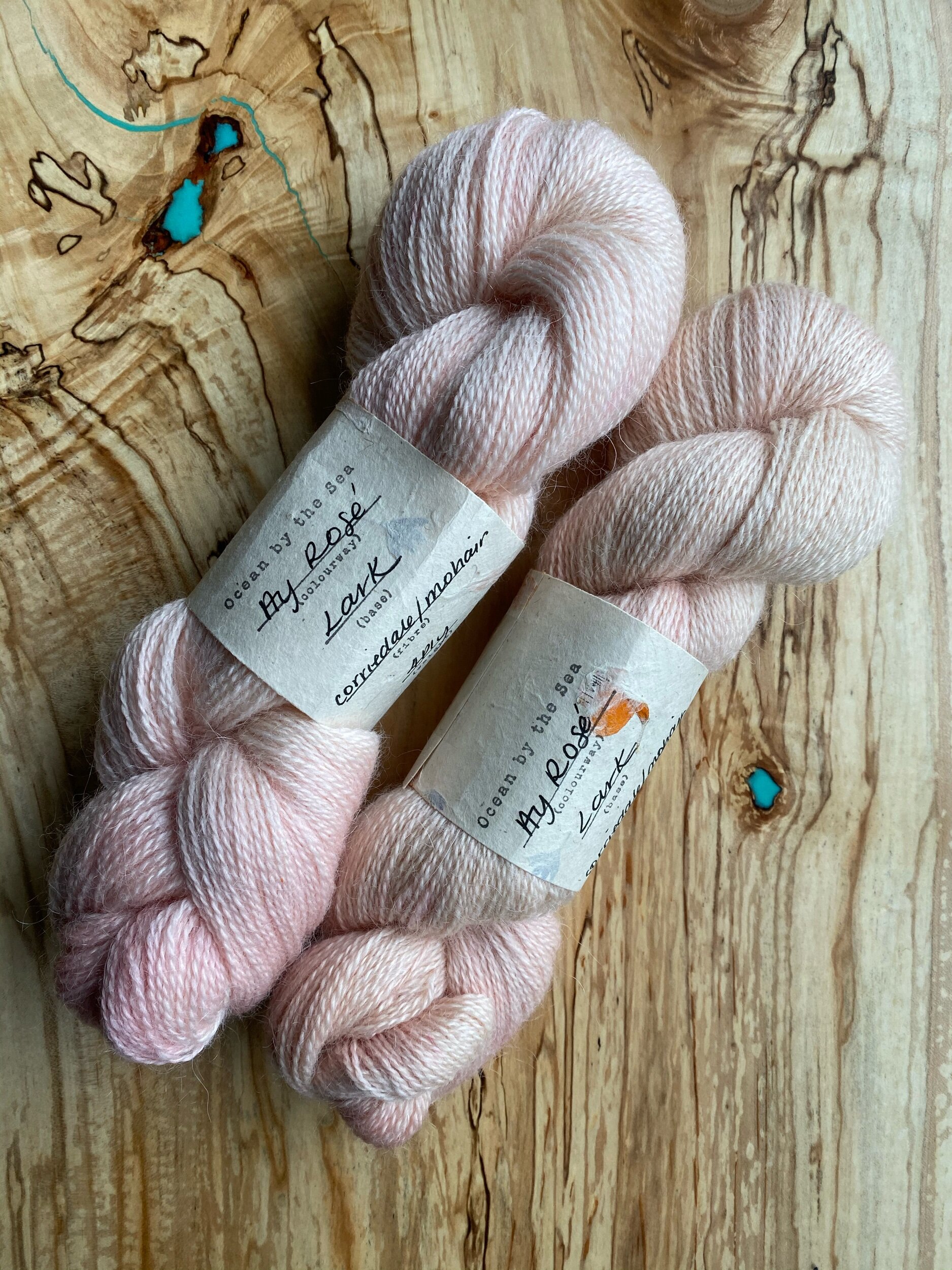  Two skeins of soft pink yarn. 