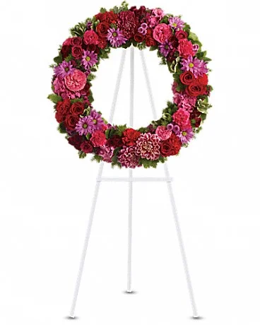 Infinite Love Dazzling blooms such as pink hydrangea, hot pink roses and carnations, red roses, spray roses and carnations, burgundy dahlias, dark pink Sweet William, lavender daisy and button spray chrysanthemums along with fern and other fresh greens create a beautiful wreath that comes delivered on an easel. Shop Now>>