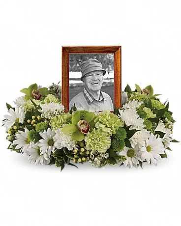 Garden Wreath An exquisite round wreath with blooms inspired by the lasting impressions a loved one makes on our lives. This luxurious wreath includes flowers such as carnations, chrysanthemums, silky green cymbidium orchid blossoms and variegated greenery. Please note: Arrangement does not include picture frame. Shop Now>>