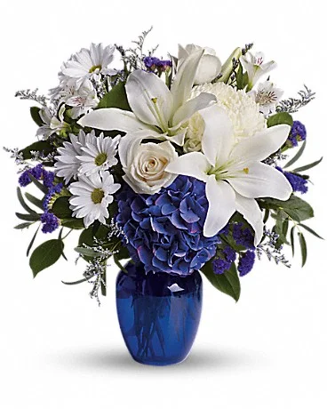 Beautiful In Blue The serenity of the color blue along with the purity of intention symbolized by white will let the family know you are sending your calm strength to them during these difficult times. Blue hydrangea, crème roses, white lilies and alstroemeria along with yellow and white chrysanthemums, eucalyptus, limonium. Buy Now>>