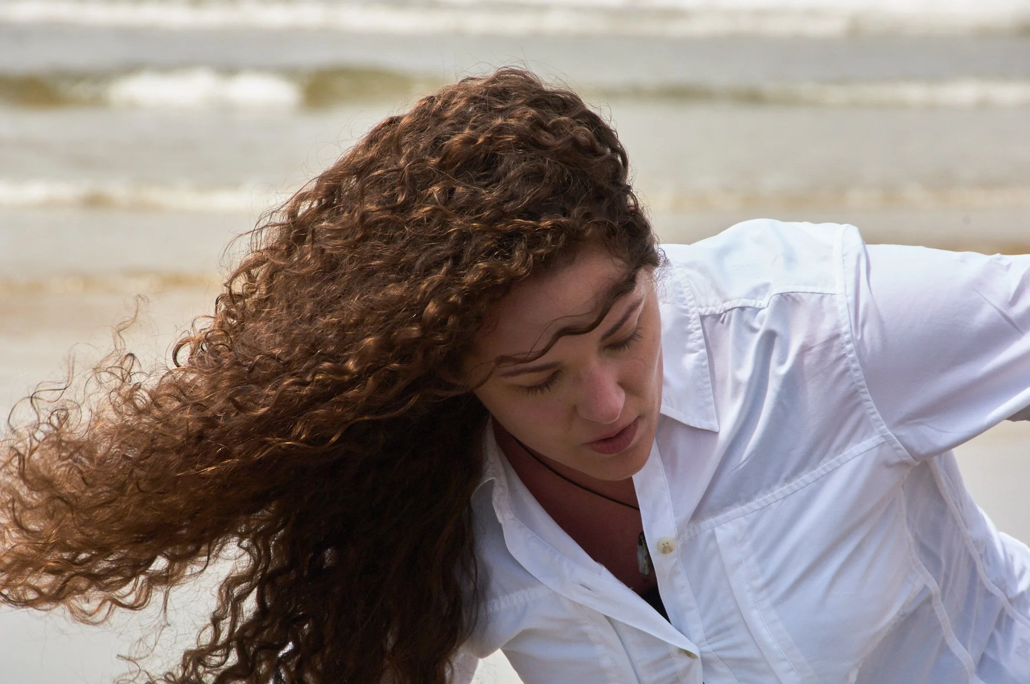Girls hair blows in the ind in a portrait on the Oregon coast