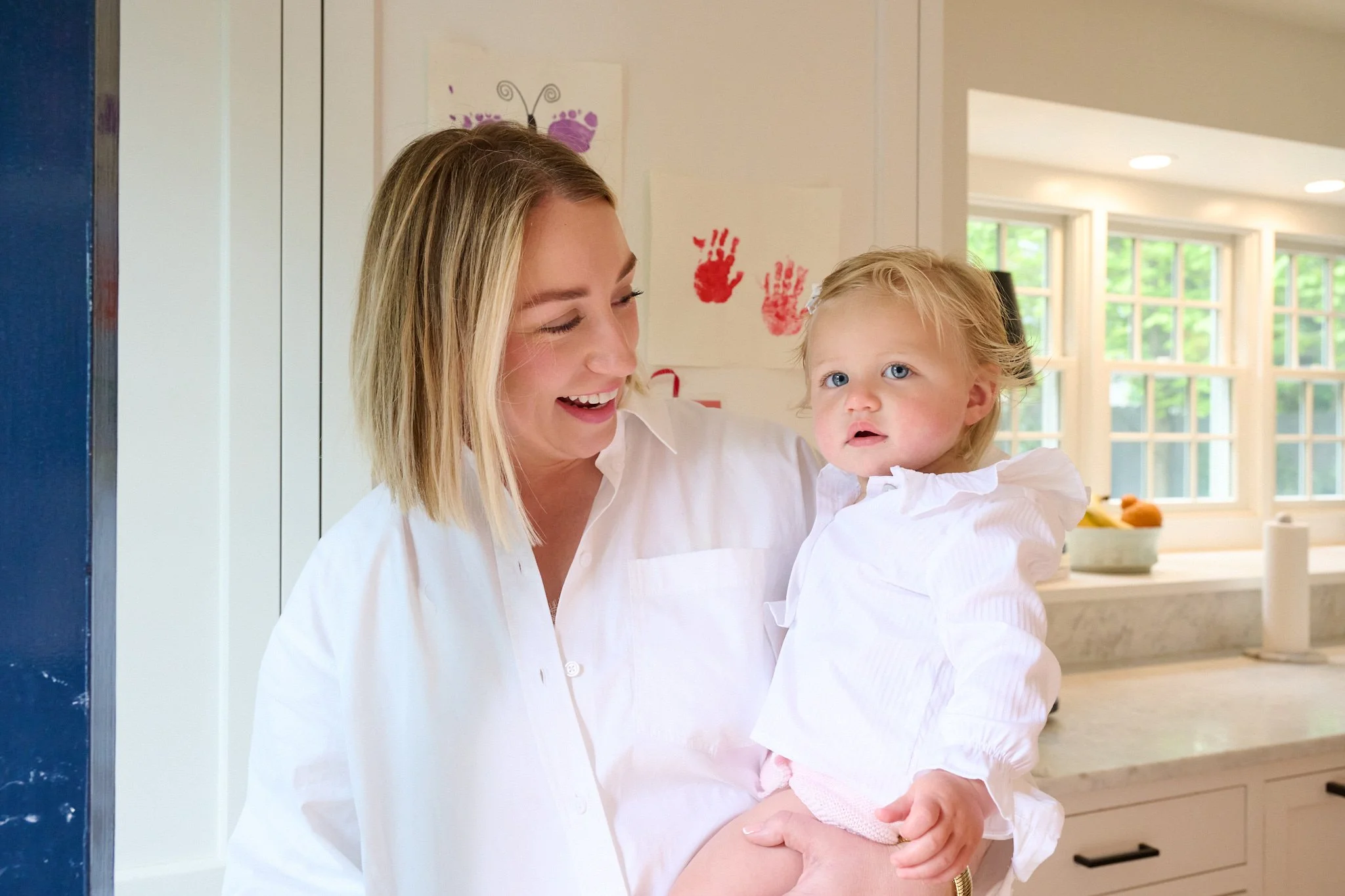  Mom is photographed holding her baby in her Greenwich CT home  