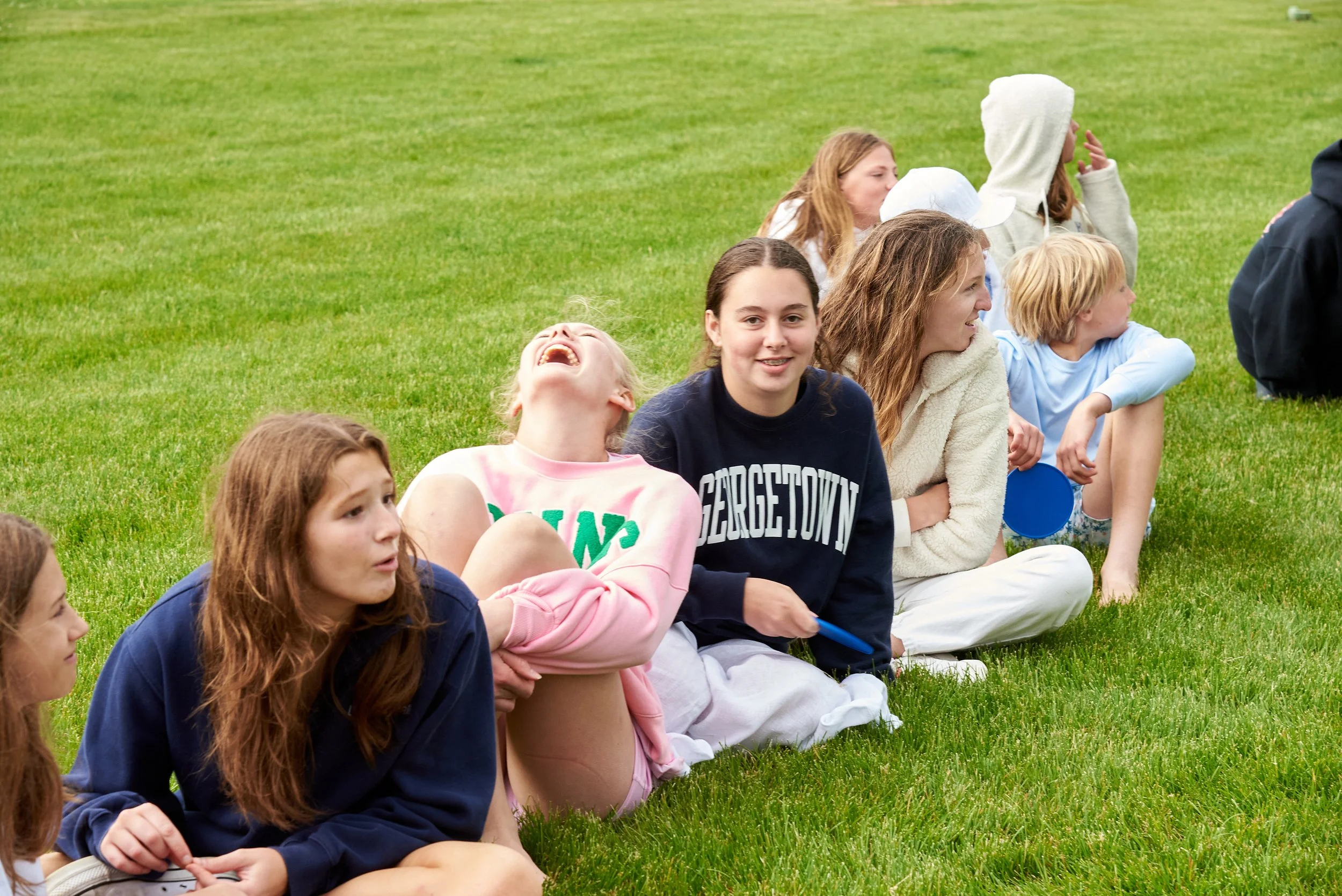 A row of teen girls laugh at a pool party in Fairfield, CT, with event photographer Pamela Einarsen